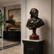 Classical Bearded Man Bust Bronze Bust, 75cm, on a rouge marble pedestal atop a black plinth in an entryway with a landscape painting and dark sideboard nearby.