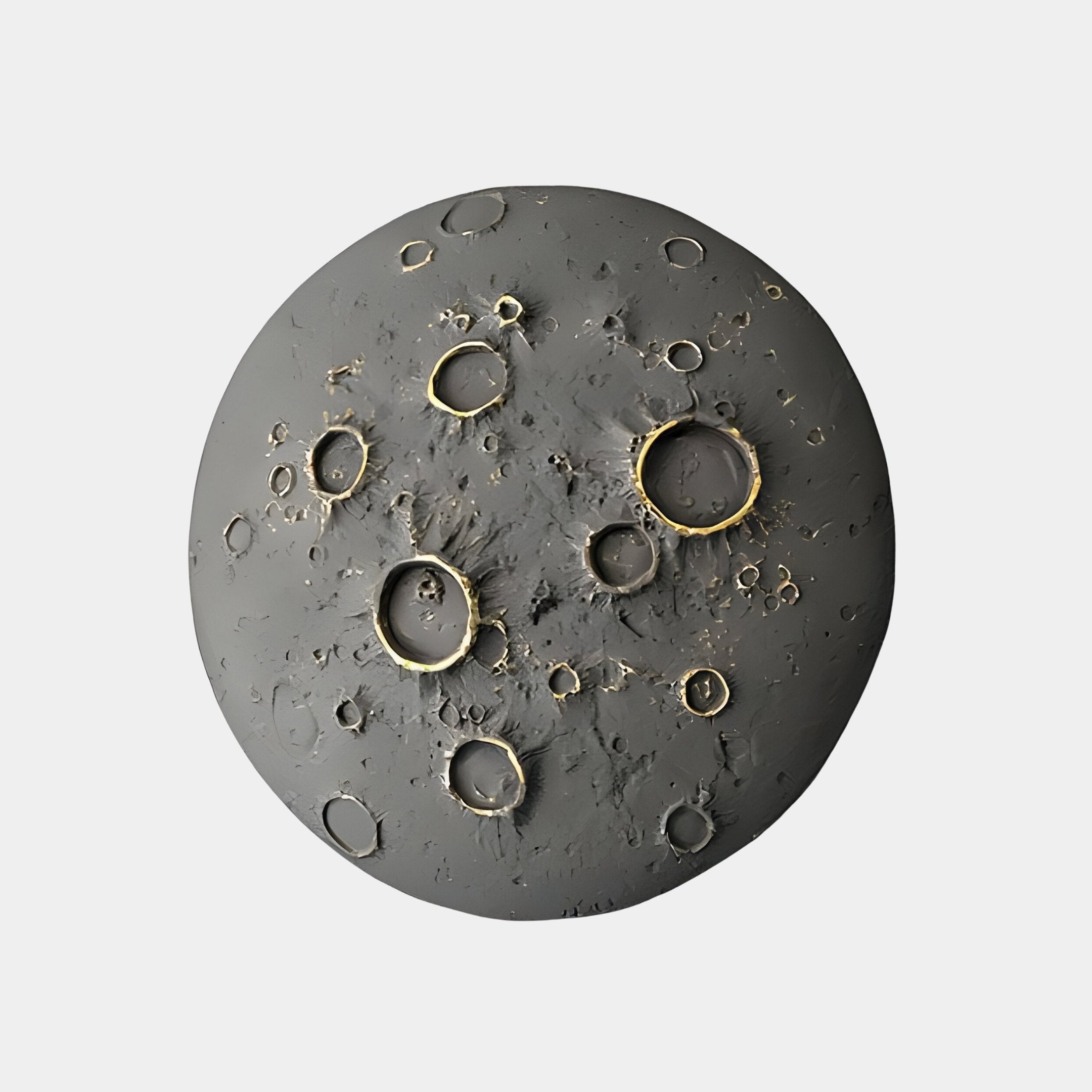 The Giant Sculptures Dark Grey 3D Lunar Impact Moon Relief Wall Art showcases a round, textured gray surface with various-sized craters highlighted in gold for contrast, set against a plain white background, creating stunning cosmic décor.