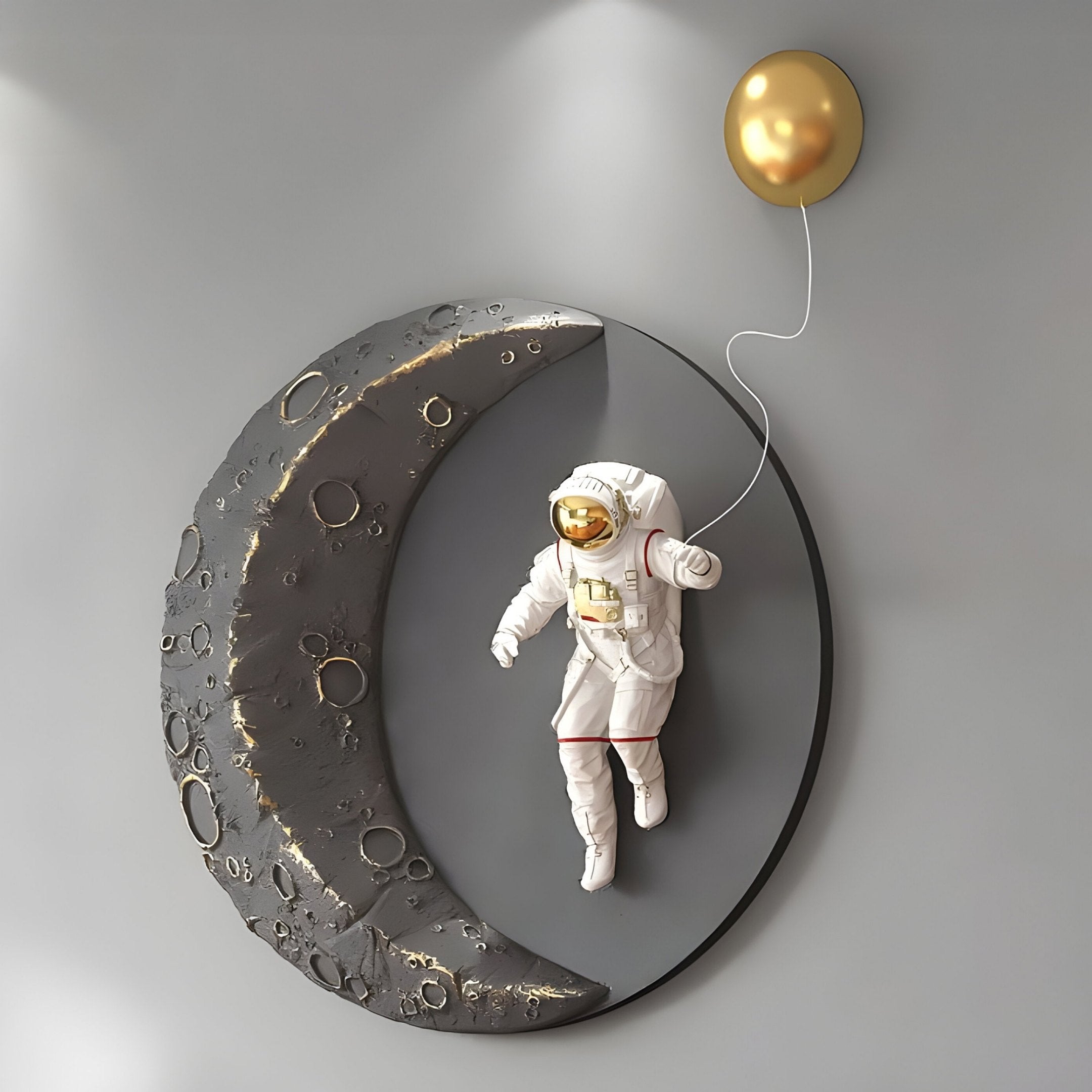 Giant Sculptures Grey & Gold 3D Lunar Balloon Astronaut Wall Art features an astronaut in a white suit floating beside a textured crescent moon against a gray backdrop, clutching a shining gold balloon, adding elegance to your home décor.