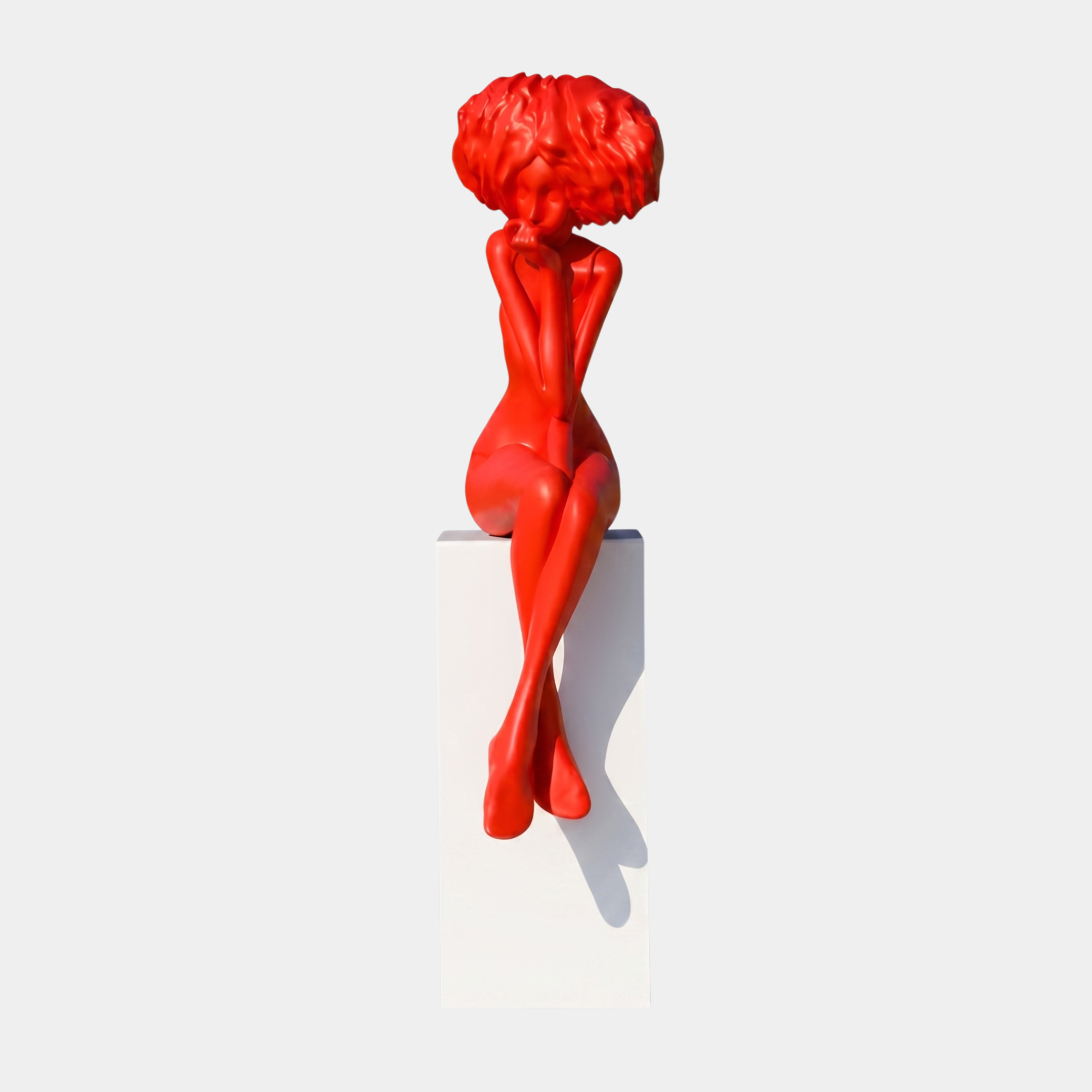 Giant Sculptures Red Abstract Female Figure with Floral Head Sculpture, 145cm, seated in a contemplative pose with matte red finish on a white plinth.