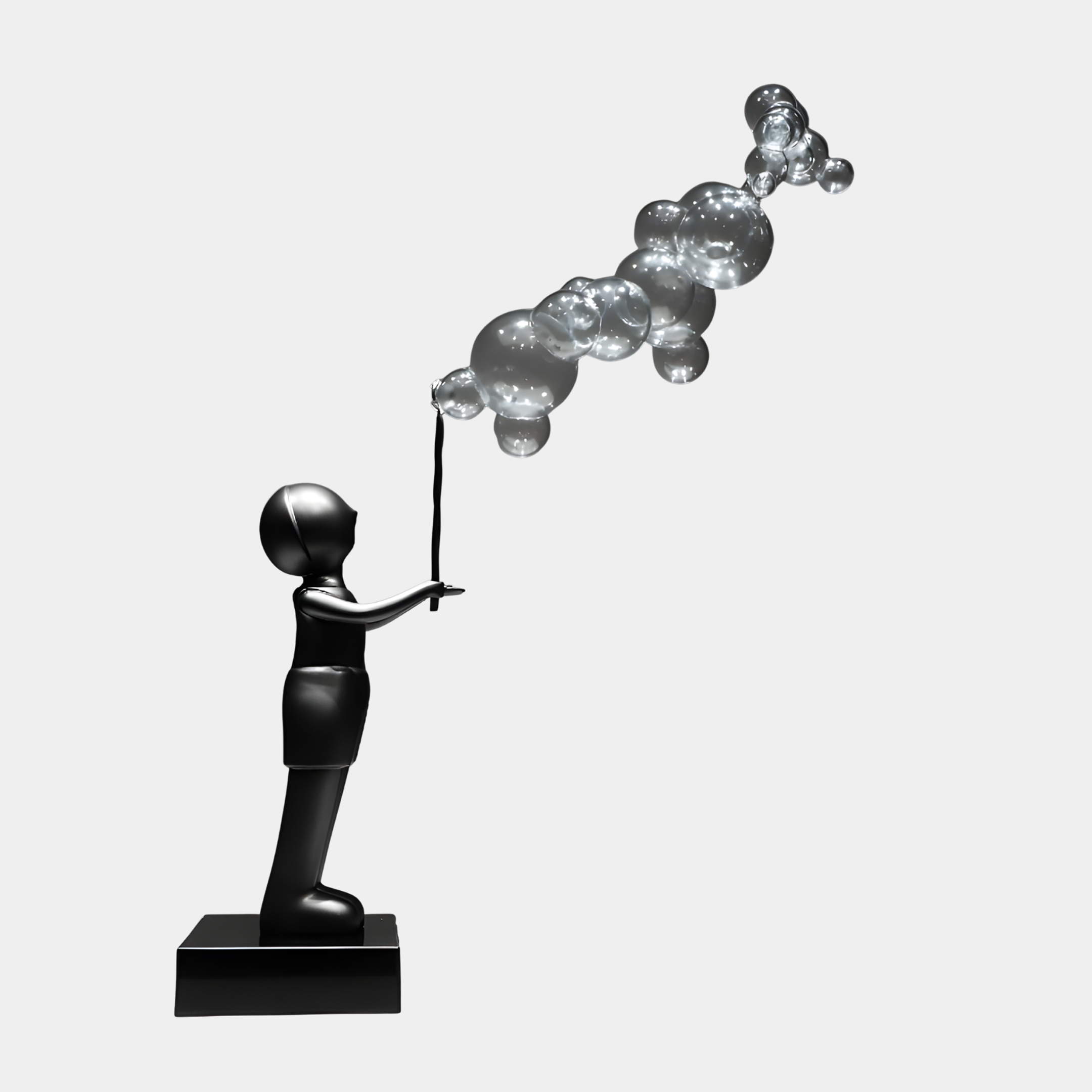 Black Figure Holding Balloon Sphere Sculpture by Giant Sculptures, a smooth 90cm figure releasing a rising cluster of silver bubbles, on a black base.