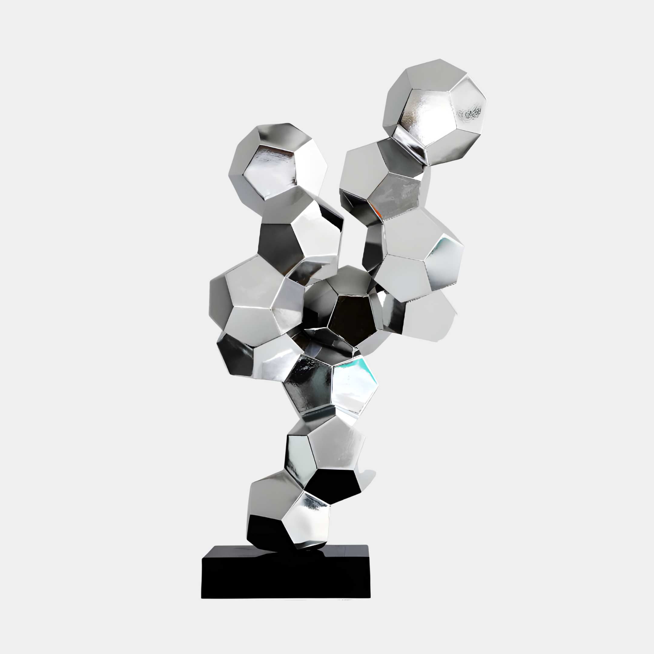 Silver Geometric Hexagon Cluster Sculpture by Giant Sculptures, faceted mirror-chrome polyhedrons stacked into a dynamic tower on a black base, plain background.