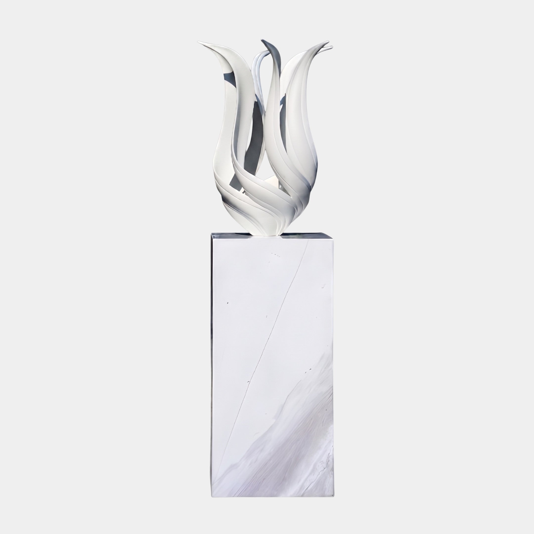 White Abstract Tulip Flame Sculpture by Giant Sculptures, with curling petal-like forms in smooth white resin, displayed on a tall white marble plinth against a plain background.
