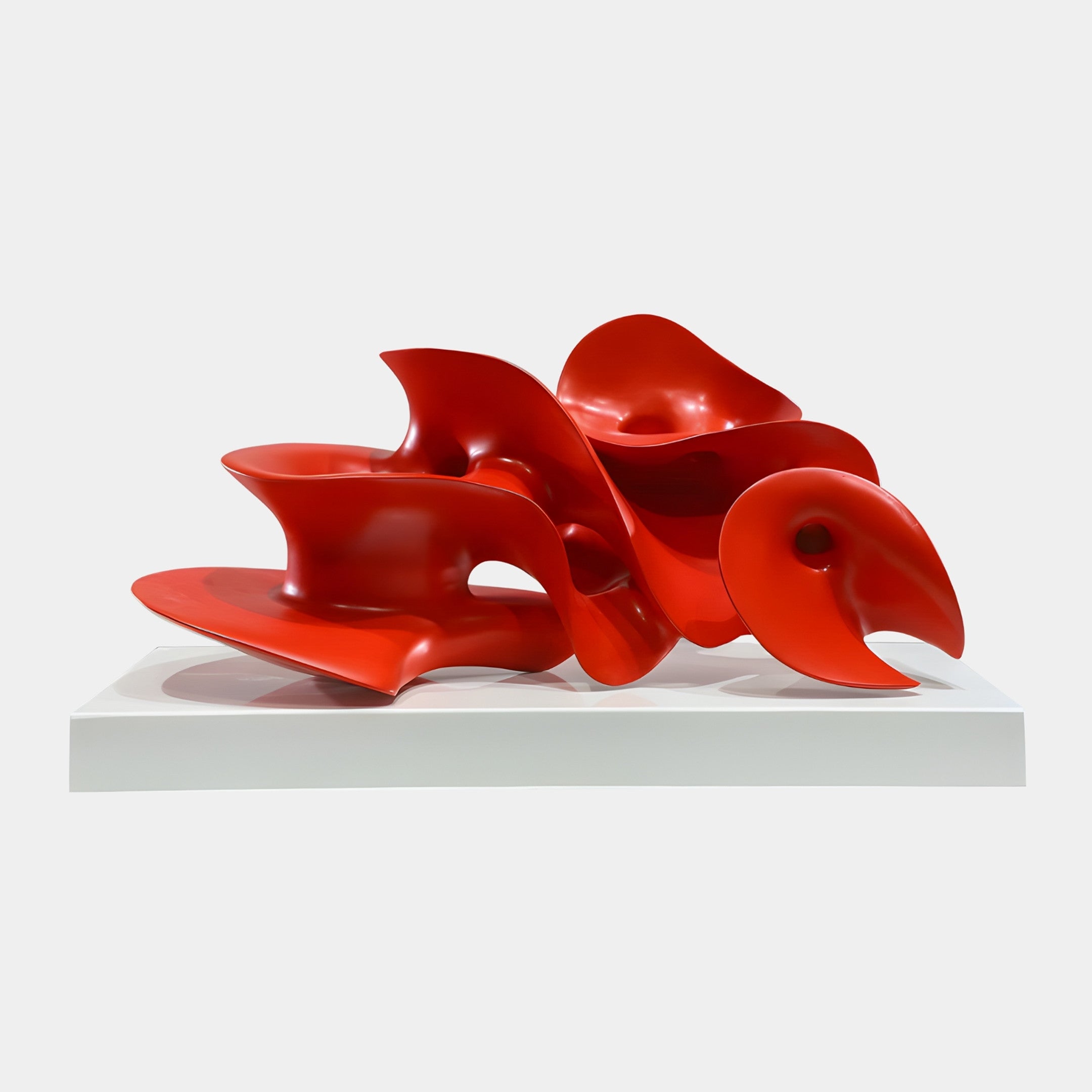 Red Abstract Organic Flowing Petal Cluster Sculpture by Giant Sculptures, glossy 3D-printed resin petals overlapping on a white marble base against a plain background.