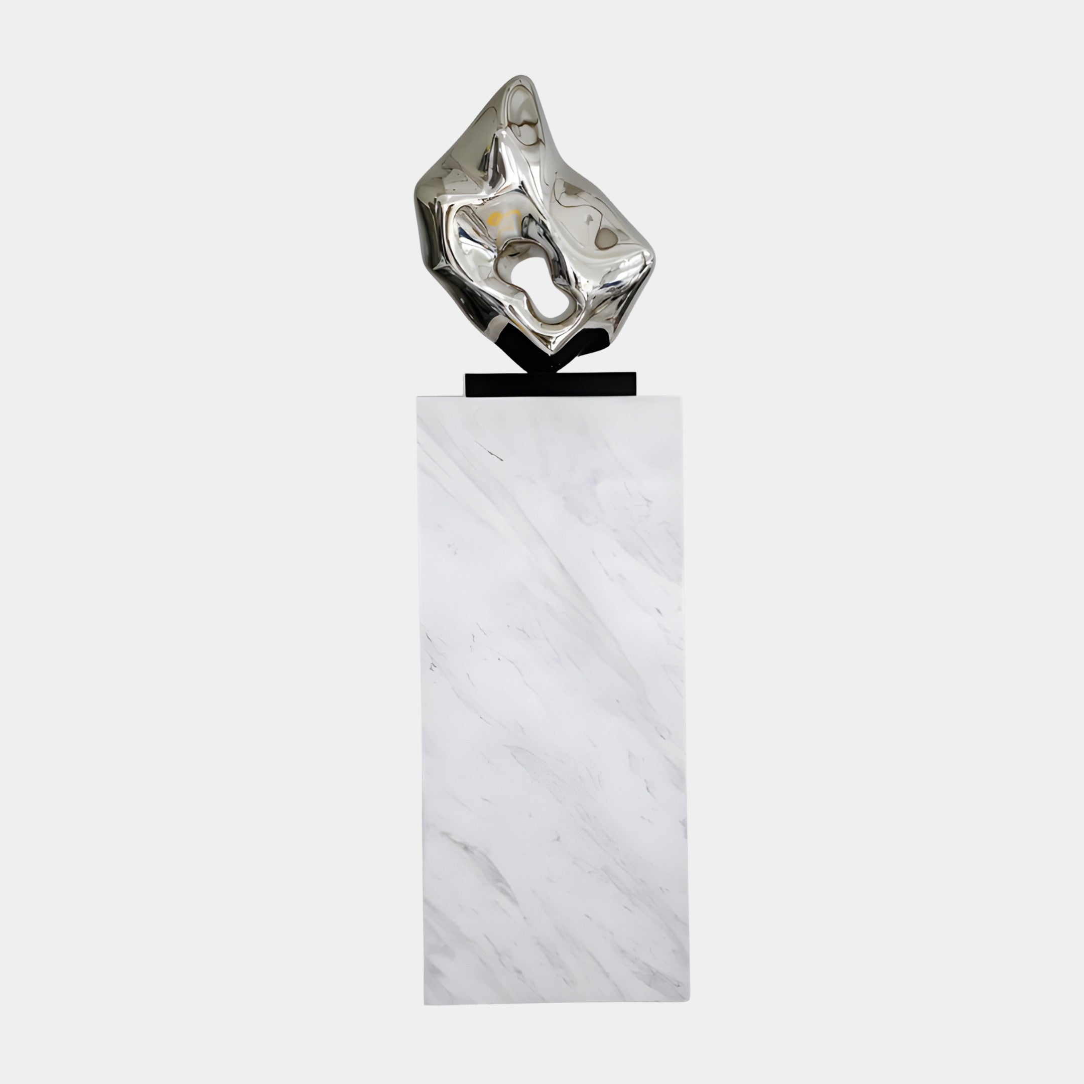 Giant Sculptures Silver Faceted Crystal Form, a mirror-finish 3D-printed resin sculpture on a tall white marble plinth, shown against a plain light background.