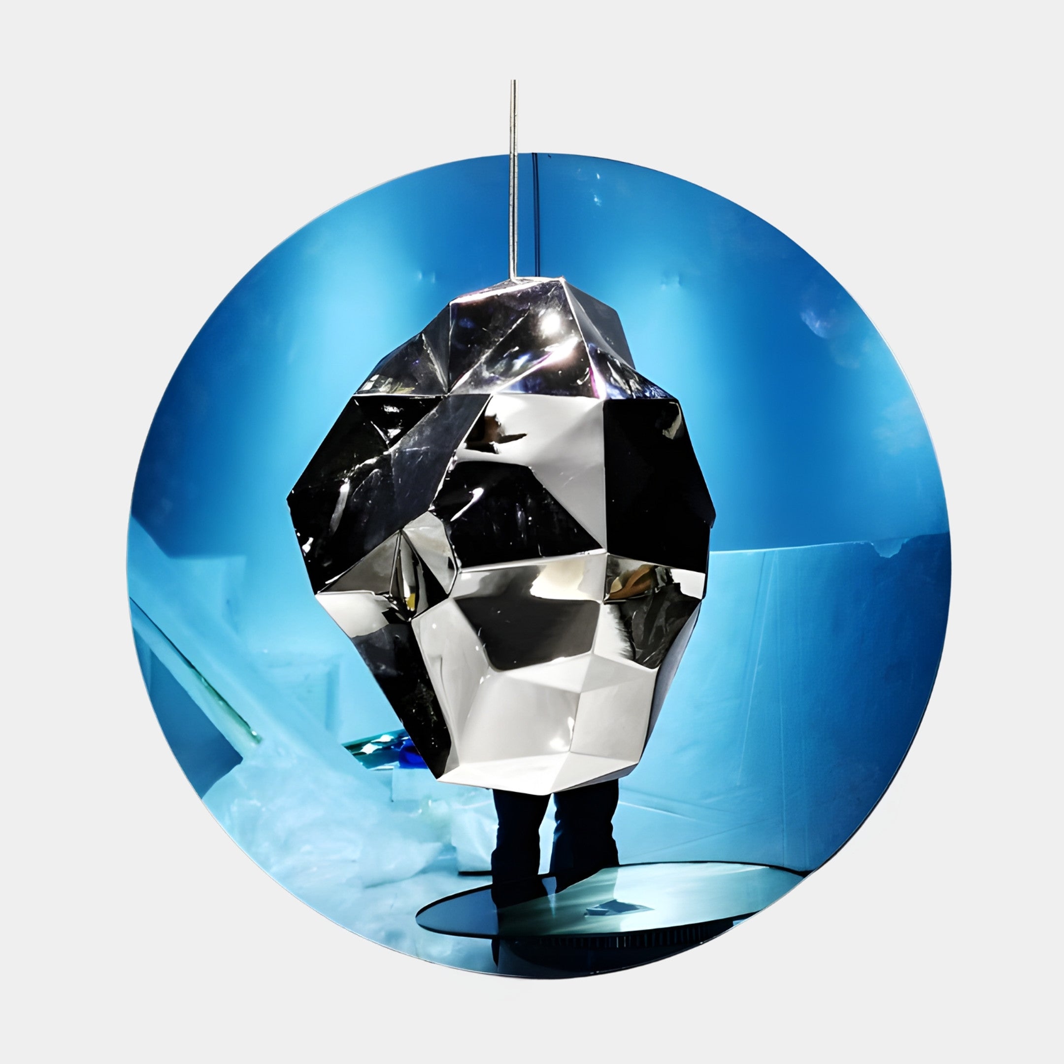Blue Sphere with Geometric Crystal Inside Sculpture by Giant Sculptures, featuring a faceted chrome crystal suspended before a glossy blue disc backdrop.