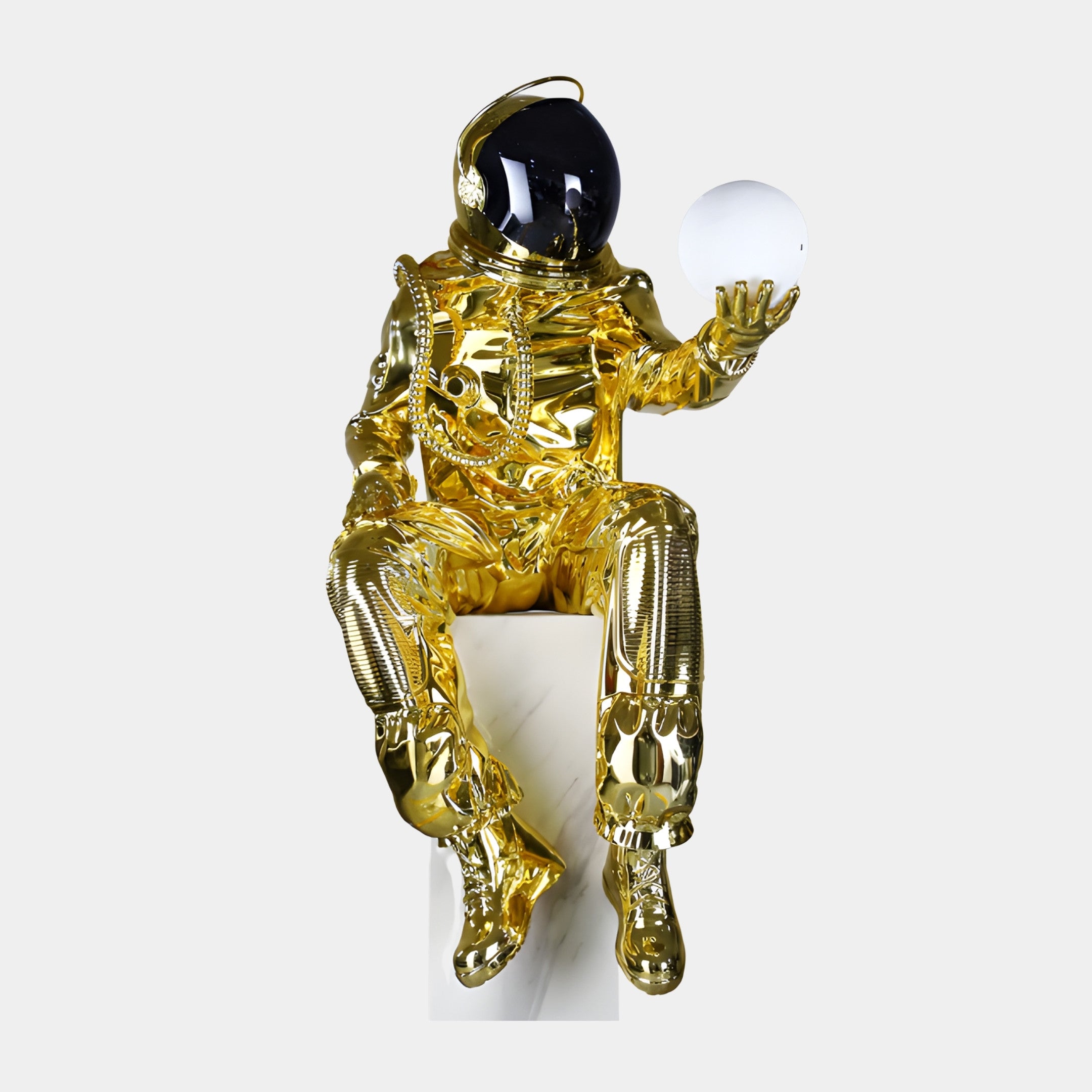 Gold Mirror-Polished Seated Astronaut with Globe Sculpture by Giant Sculptures, 140cm, seated on a white plinth holding a glowing white orb, dark visor.