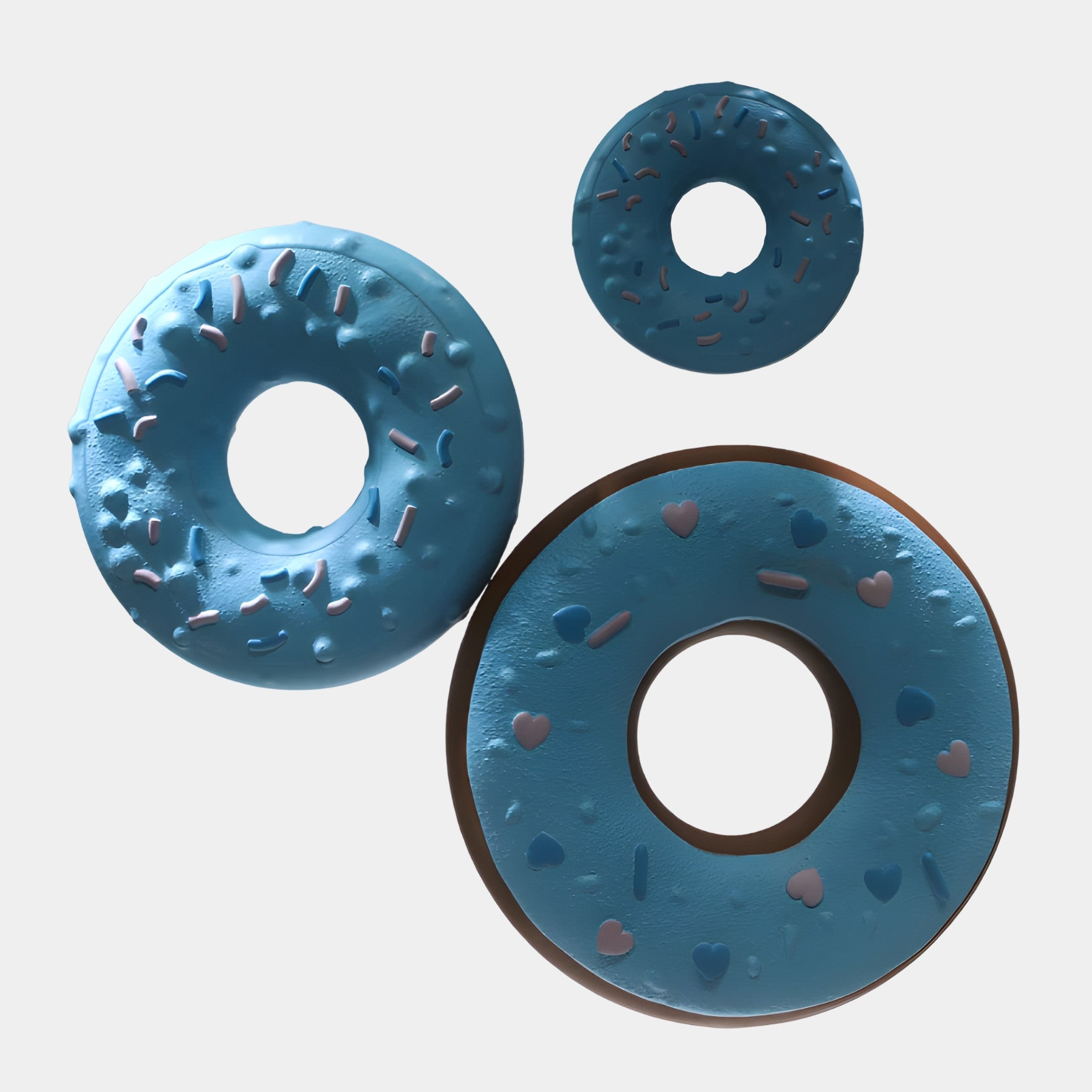 Blue Abstract Donut Trio Hanging Sculpture by Giant Sculptures in 3D-printed resin, shown from above with pastel pink and blue sprinkles and hearts on a plain background.