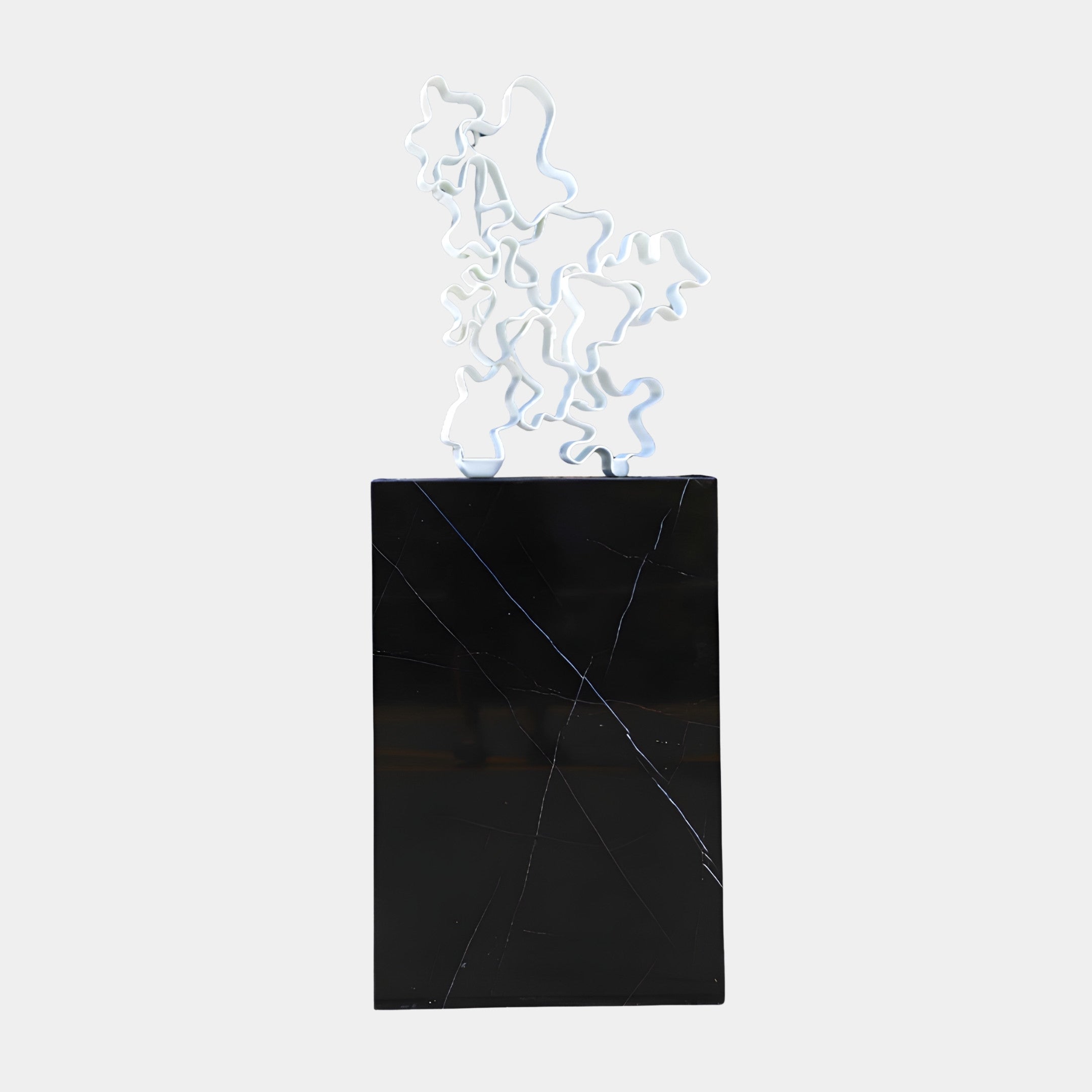 White Wire Mesh Abstract on Black Marble Plinth Sculpture by Giant Sculptures, featuring a looped tangled ribbon form in 3D-printed resin on a veined black marble base.