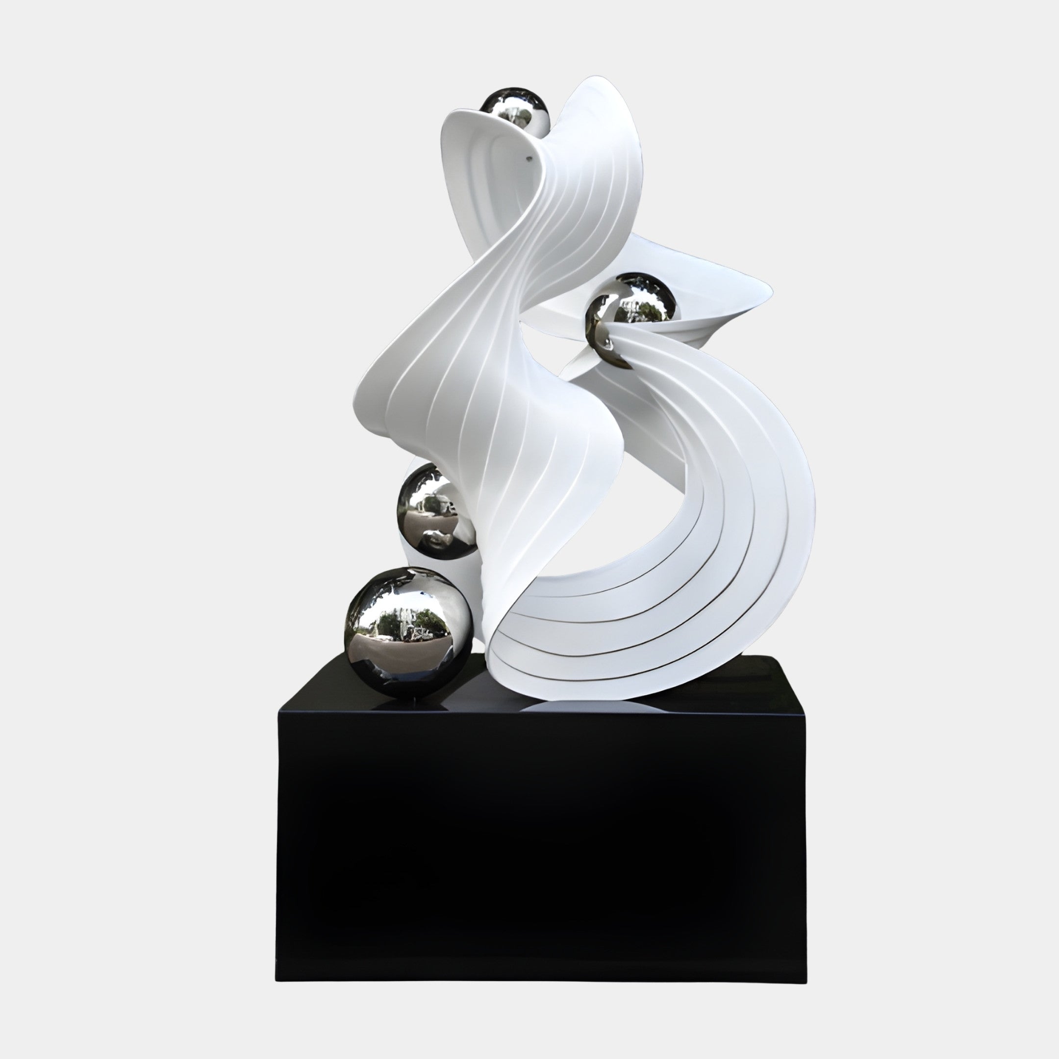 White Pleated Abstract Wave with Chrome Spheres Sculpture 170cm by Giant Sculptures, ribbed swirling resin form with mirrored silver orbs on a black base.