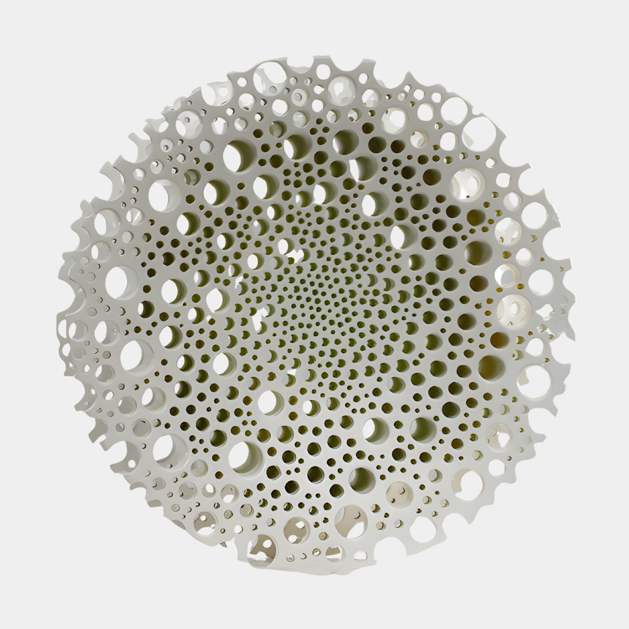 Giant Sculptures White Perforated Circle Disc Sculpture in 3D-printed resin, front view showing graduating holes radiating from the centre, on a plain background.