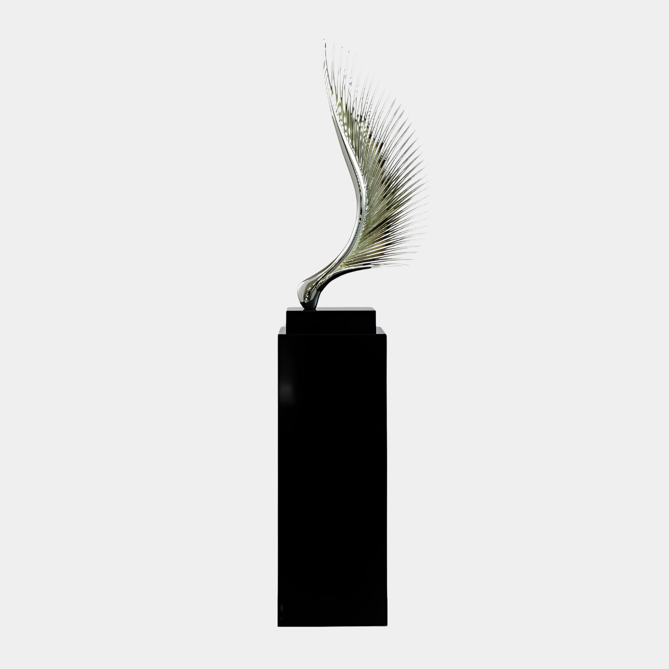Silver Feather Quill on Black Base Sculpture by Giant Sculptures, chrome-finish 3D-printed resin fanning upward from a tall black plinth on a plain background.