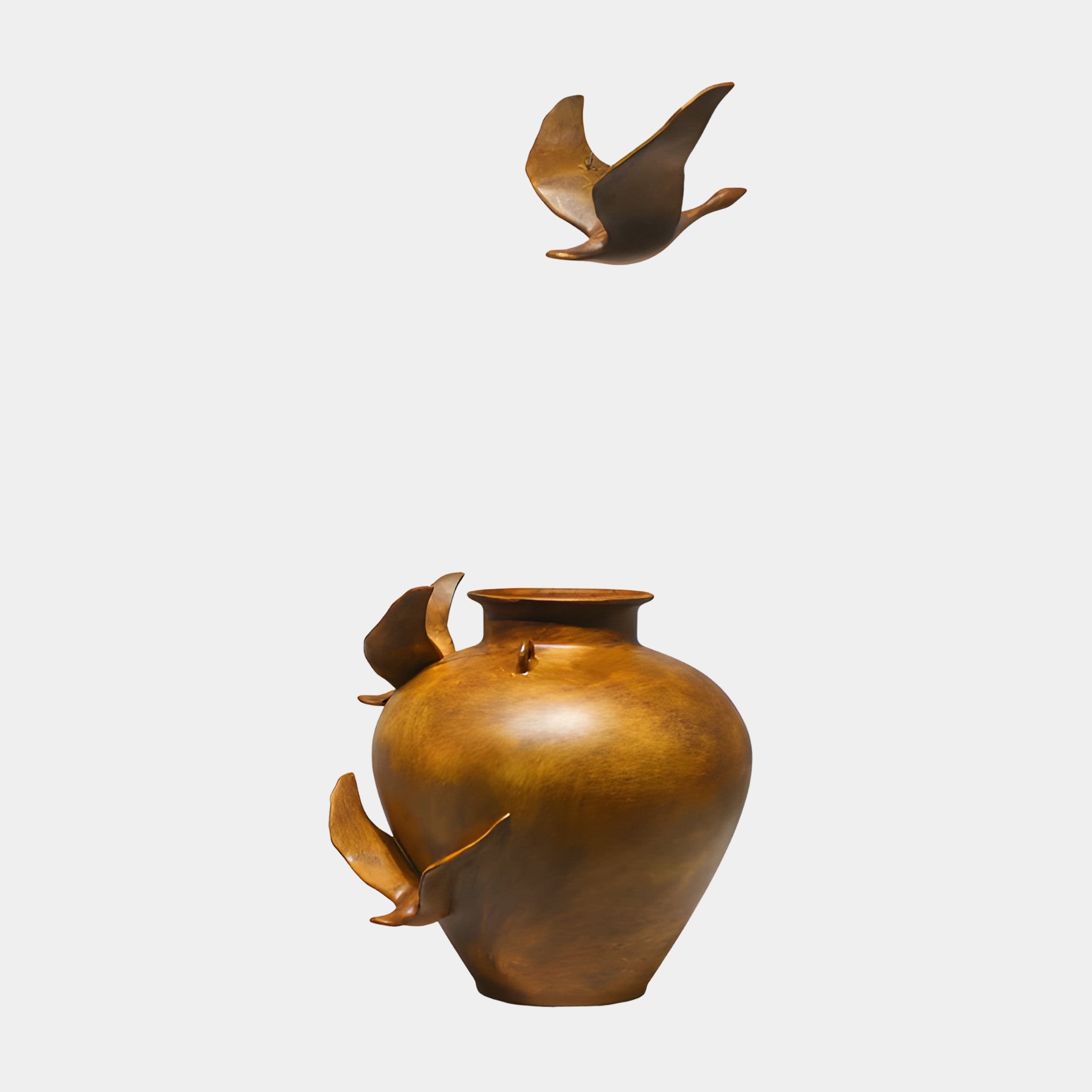 Bronze Bird in Flight Sculpture by Giant Sculptures, 39cm, featuring a swallow soaring above a rounded bronze vessel with perched birds, on a plain background.