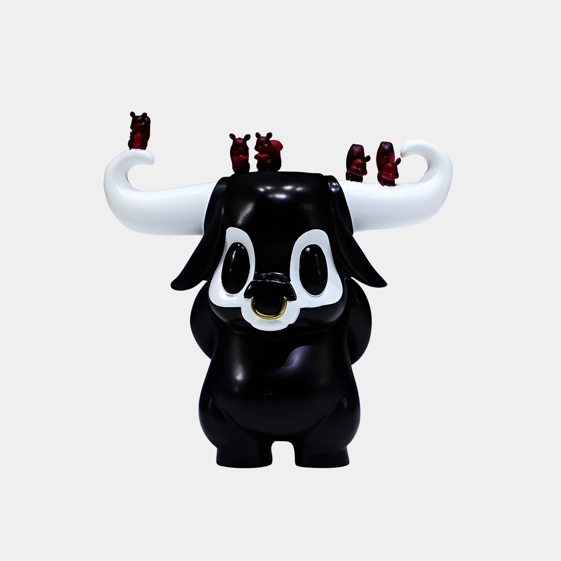 Black Bull Character with Big Eyes Sculpture by Giant Sculptures, glossy 3D-printed resin figure with white horns, gold nose ring, and red mini bulls perched on top.