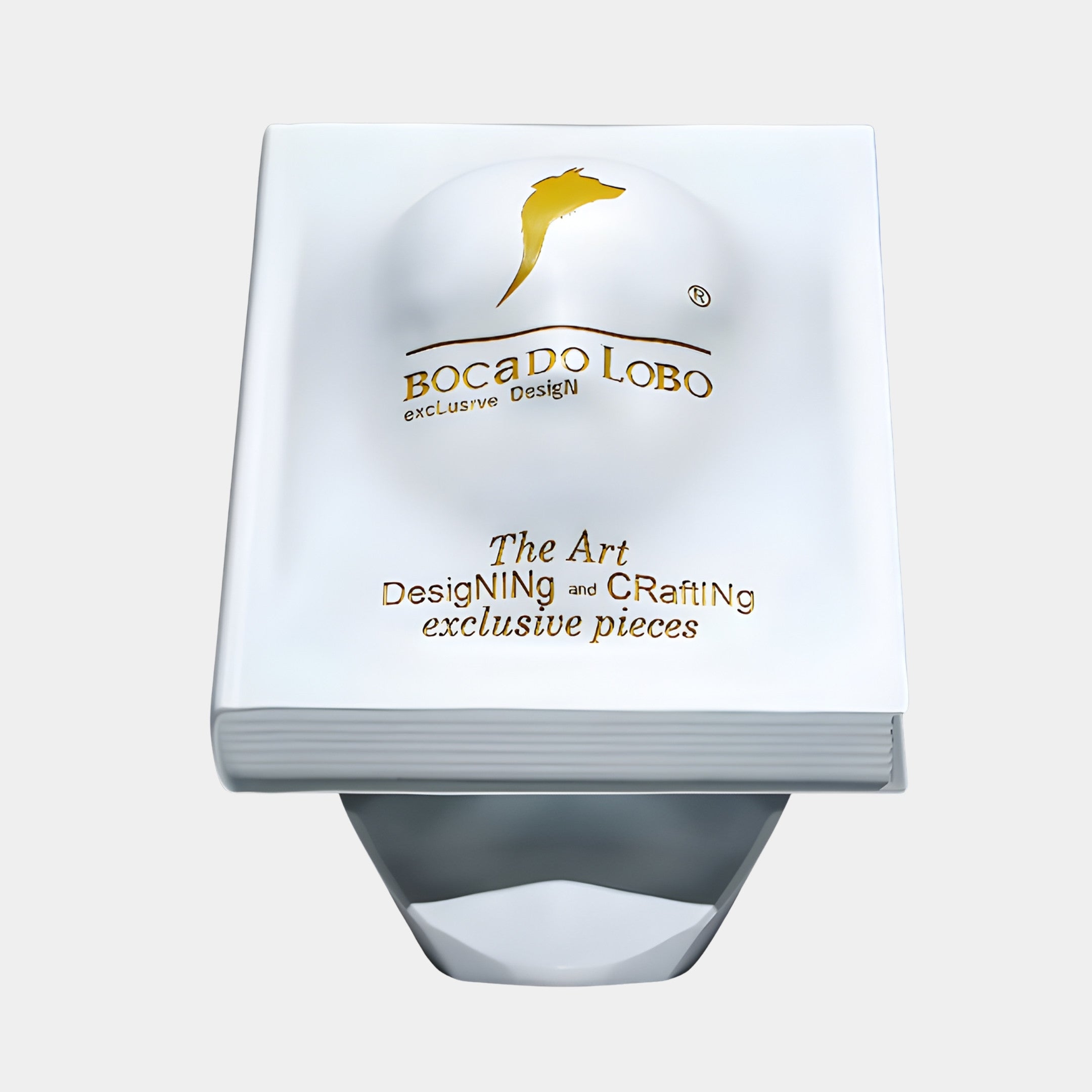 White Display Podium 40cm by Giant Sculptures, shaped like a closed book in matte white 3D-printed resin with gold Bocado Lobo branding on the cover.
