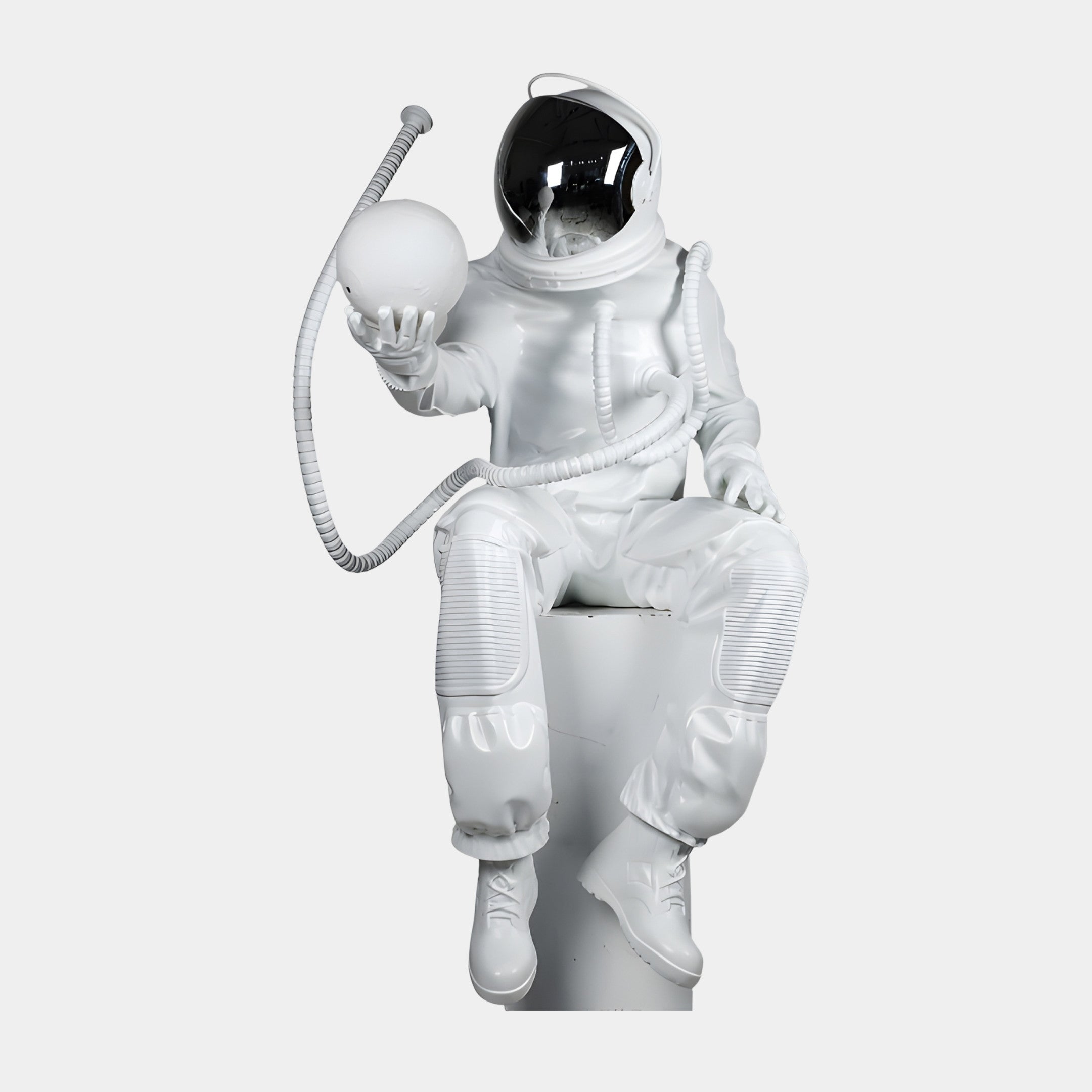 Seated White Astronaut Holding Sphere Sculpture 140cm by Giant Sculptures in glossy white resin with chrome visor and curling helmet tube, on a plain background.