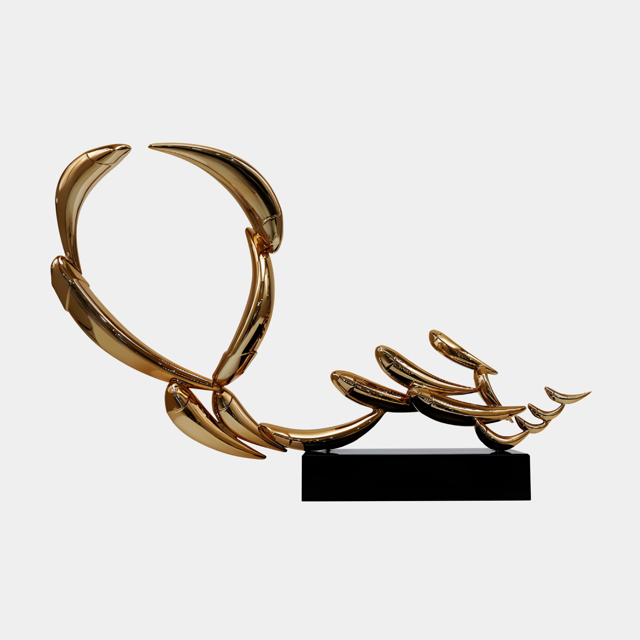 Gold Abstract Flowing Ribbon Loop Sculpture from Giant Sculptures, featuring curved blade-like forms in mirror-bright gold on a black rectangular base against a white background.