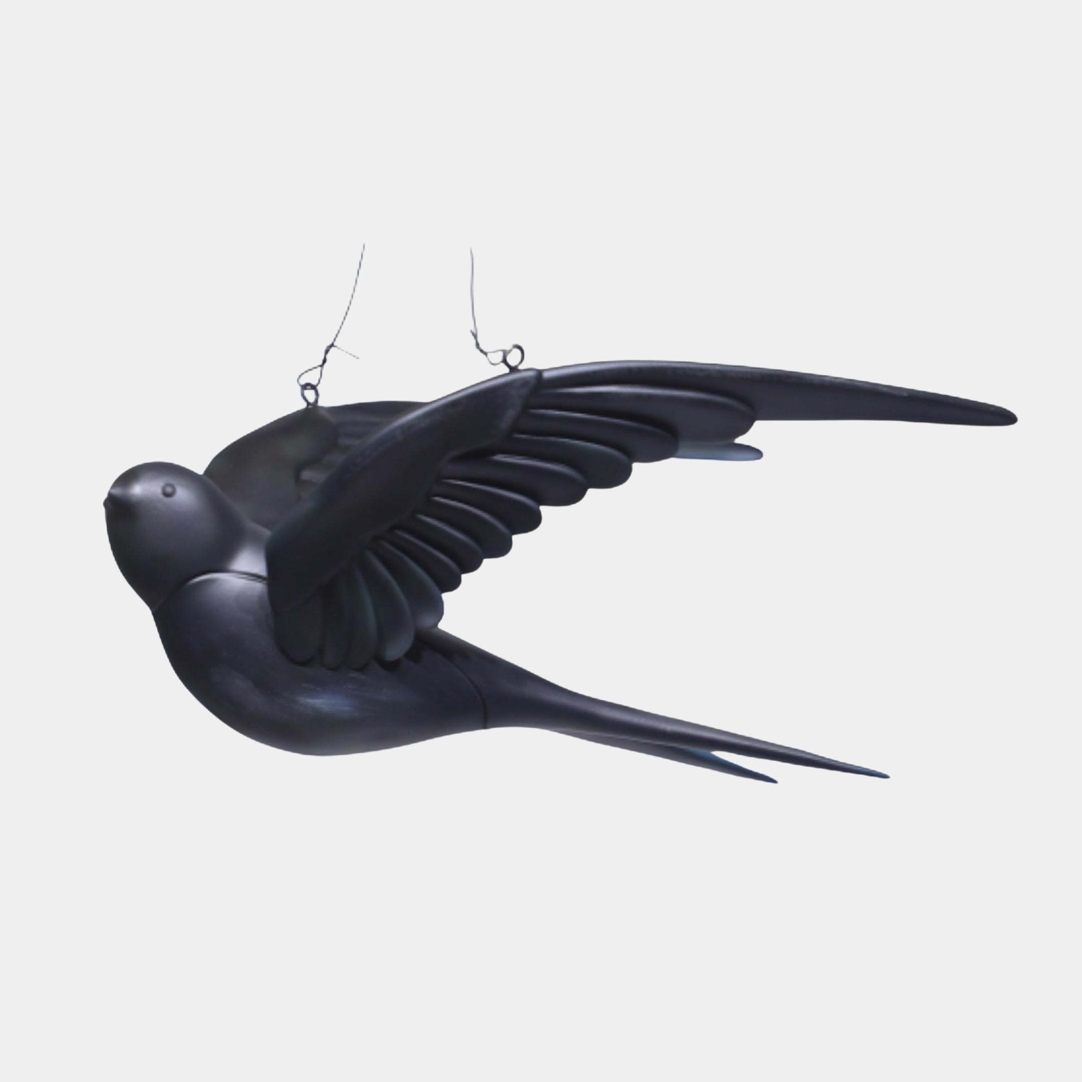 Black Suspended Swallow Bird Sculpture by Giant Sculptures, 22cm matte black 3D-printed resin bird with swept wings and forked tail, hung on a plain background.