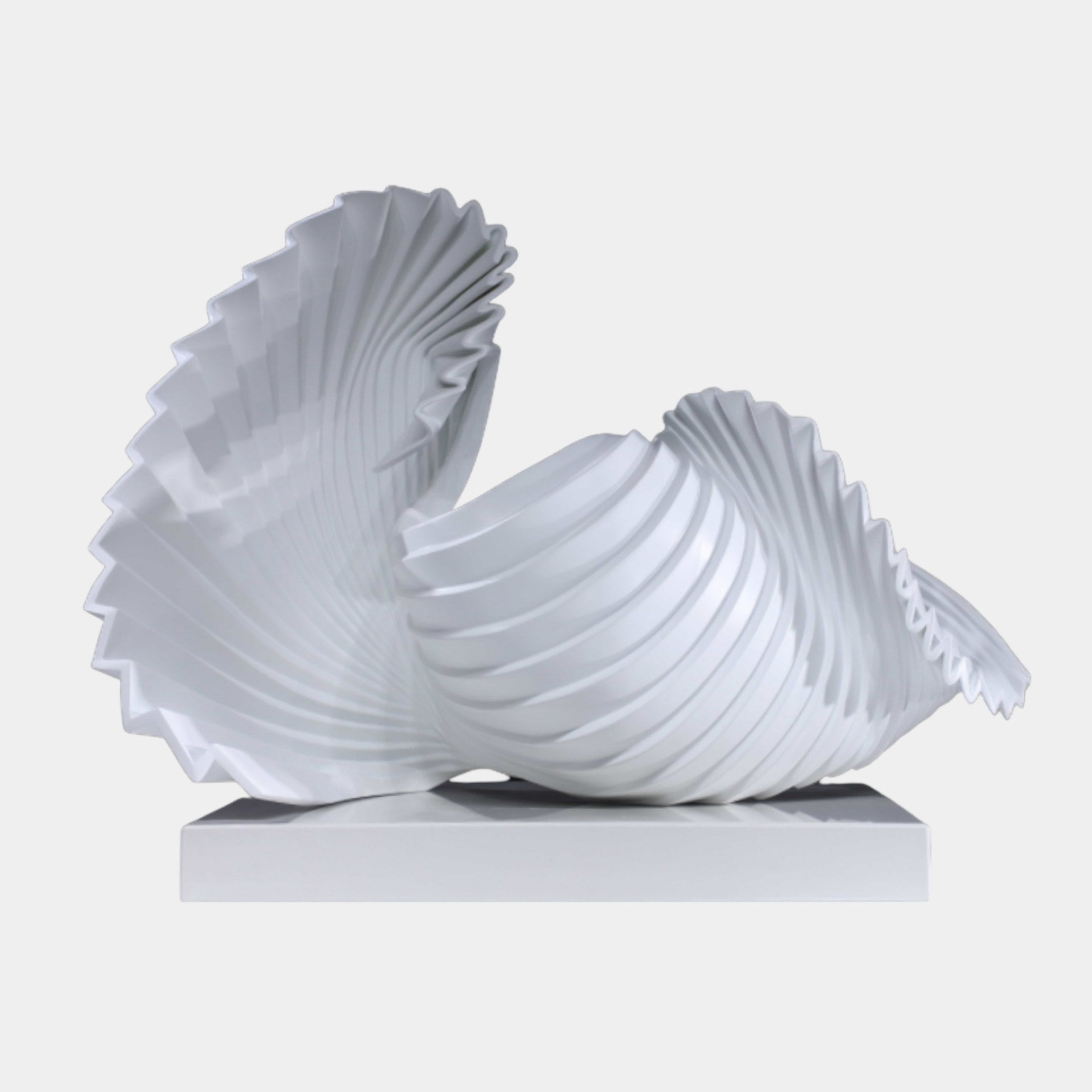 White Pleated Shell Fan Sculpture by Giant Sculptures, two overlapping fan-folded shell forms in crisp white resin on a rectangular base, shown against a plain background.