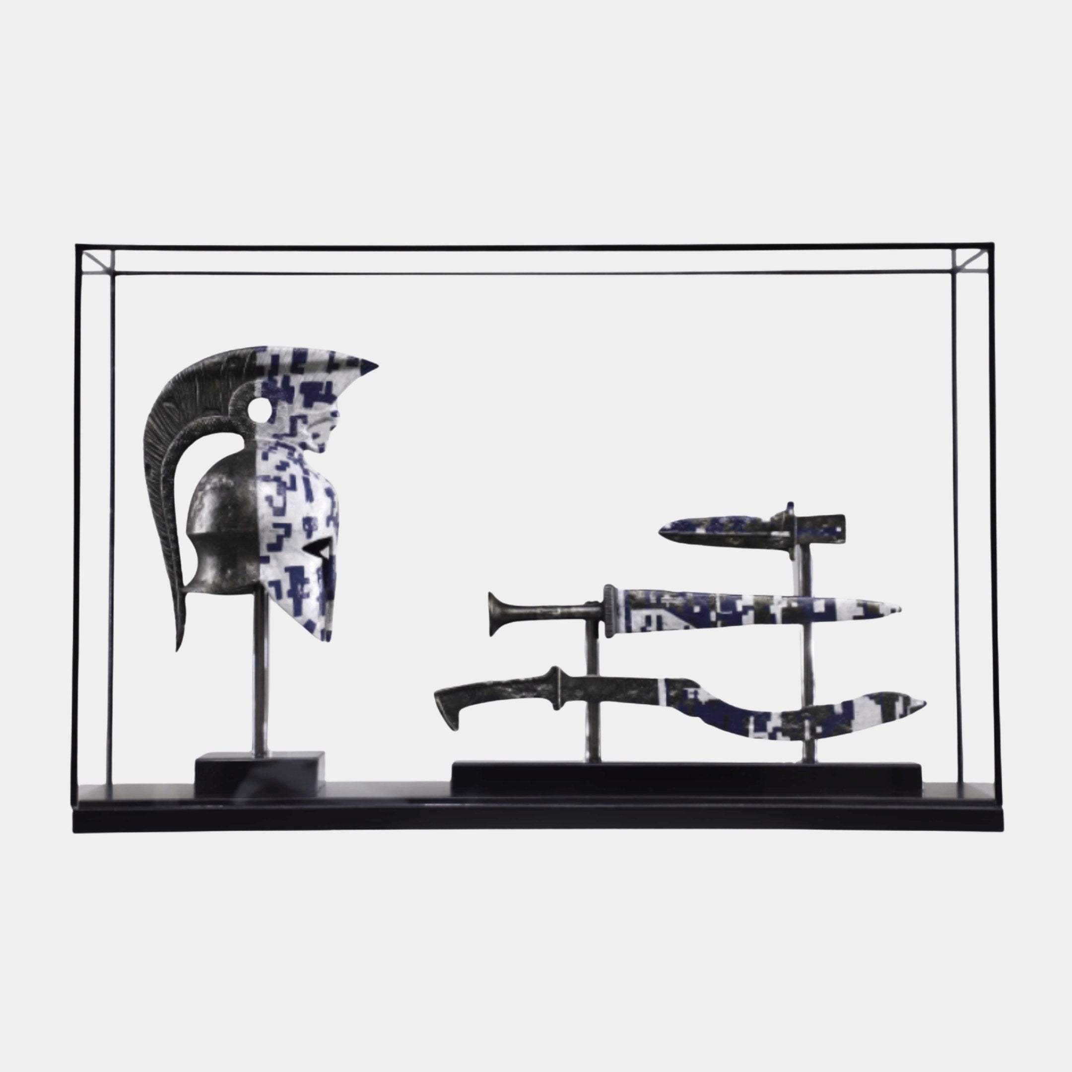Giant Sculptures Black Framed Helmet & Daggers Display, 110cm, showing a crested Greek helmet and three daggers in blue-and-white camo finish on a plain background.