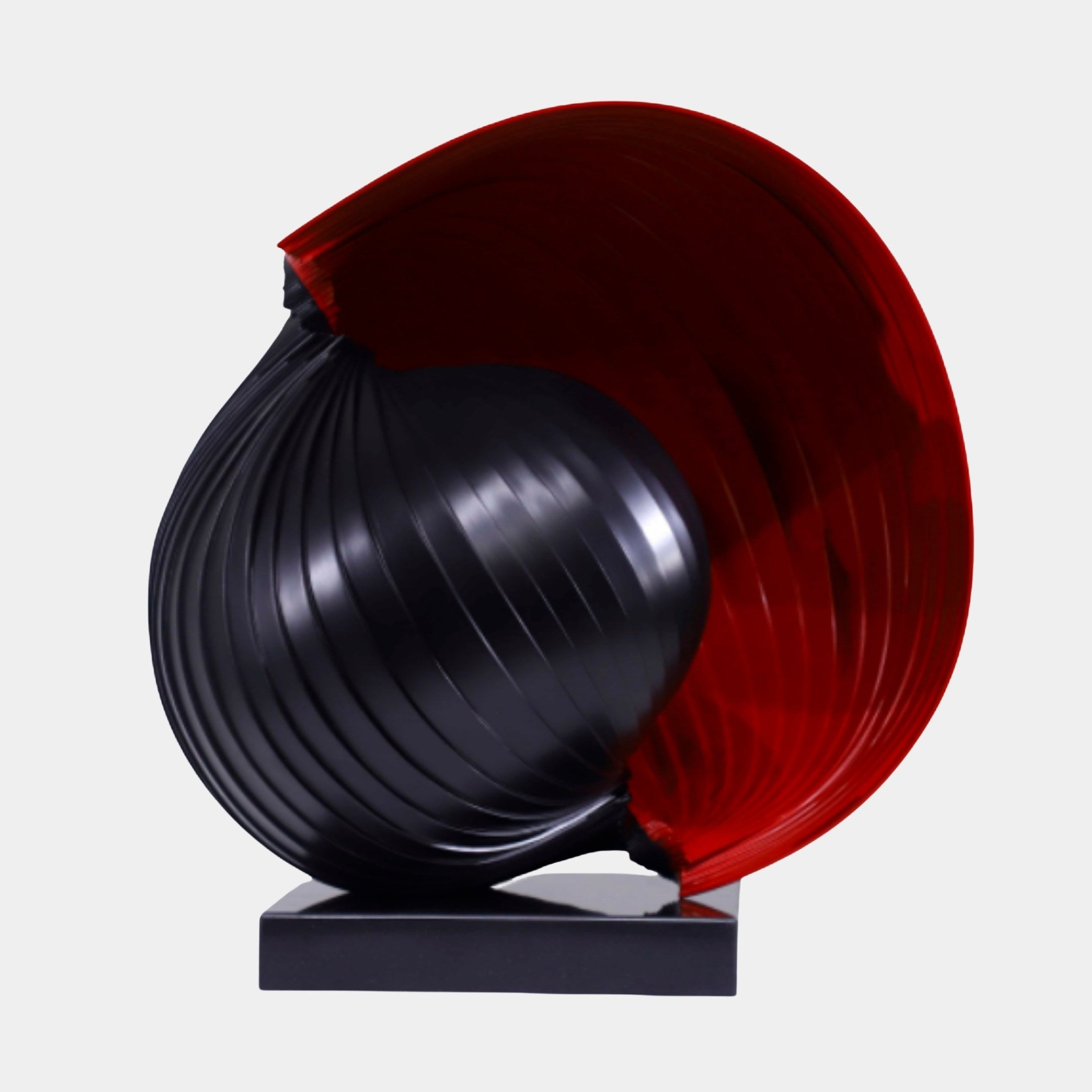 Red and Black Abstract Sphere Pair Sculpture by Giant Sculptures, featuring a ribbed matte black sphere cradled within a glossy translucent red shell on a black base.