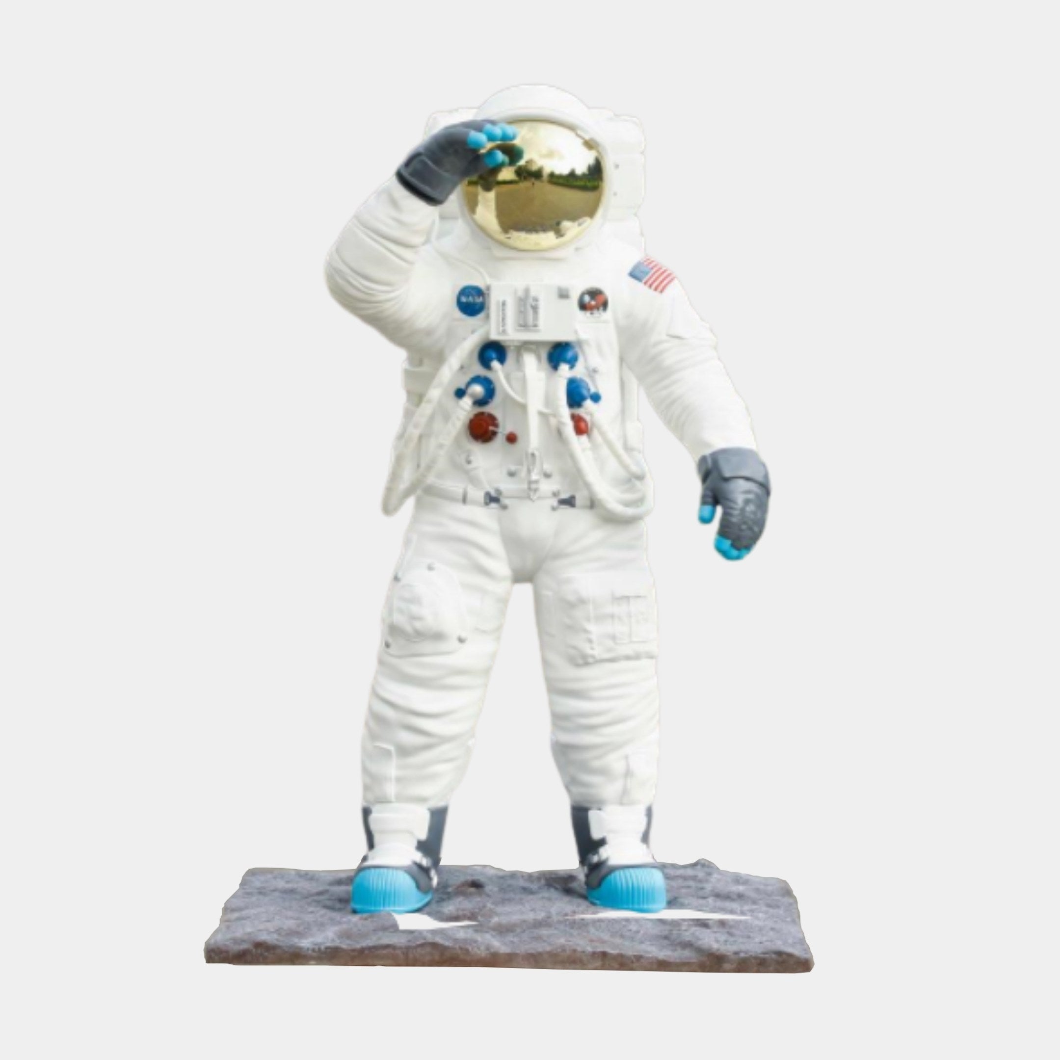 White Astronaut with Blue Backpack Sculpture by Giant Sculptures, 116cm 3D-printed resin figure shielding a gold visor on a moon-rock base against a plain background.