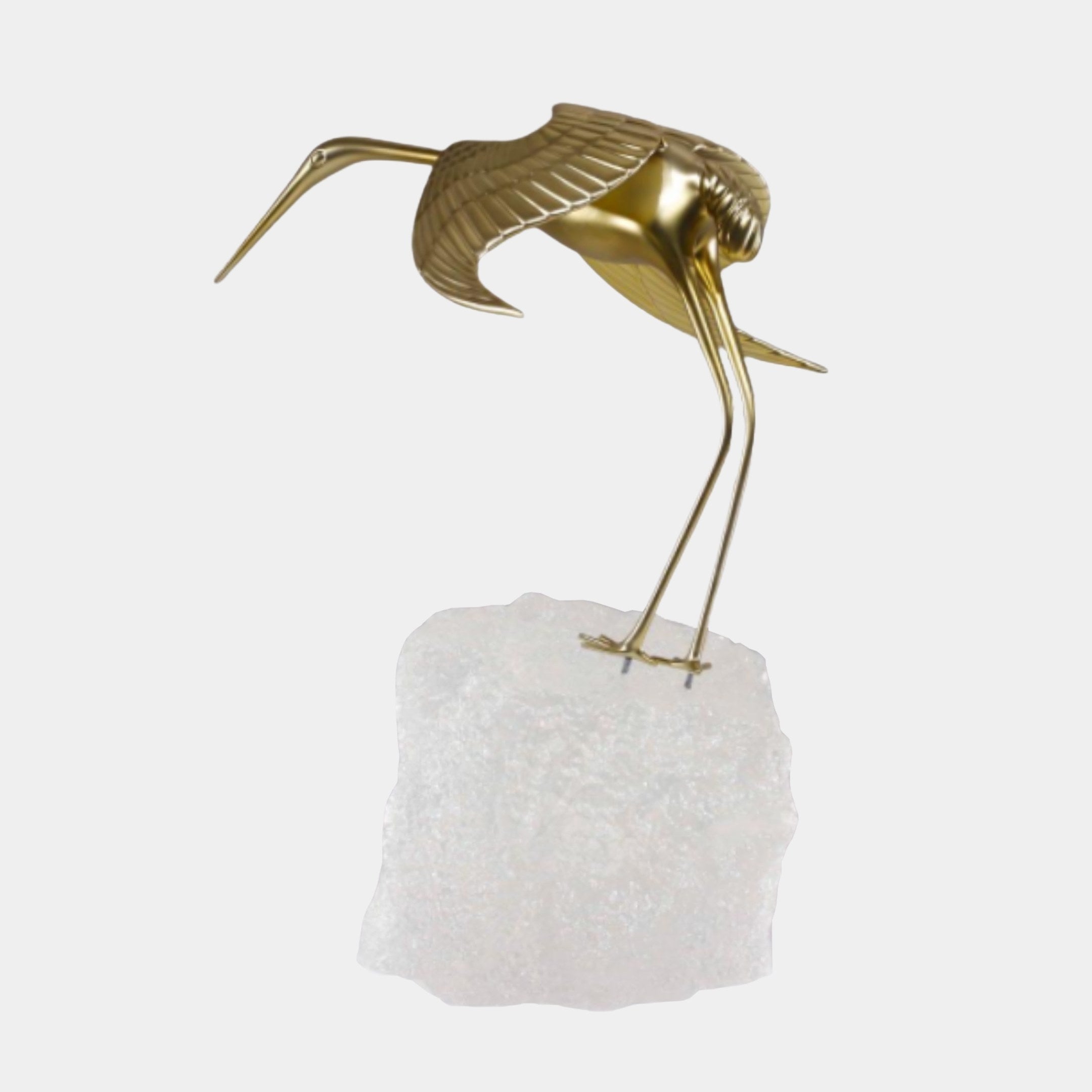 Gold Crane Bird on Stone Base Sculpture by Giant Sculptures, shown mid-motion with outstretched wings and slender legs on a rough white stone base.