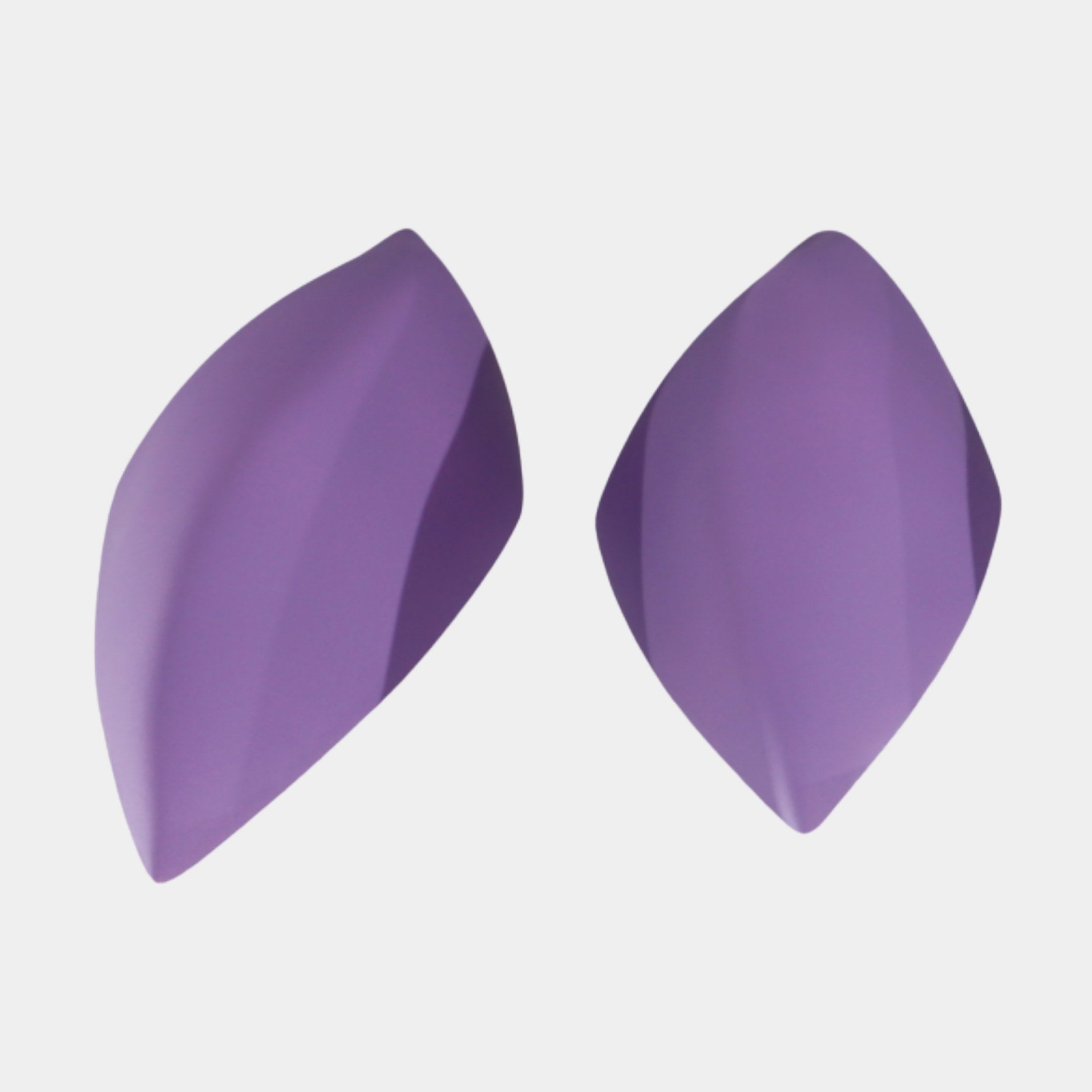 Giant Sculptures Purple Frosted Petal Pair, two matte purple resin petal forms with smooth twisting curves tapering to points, shown on a plain white background.