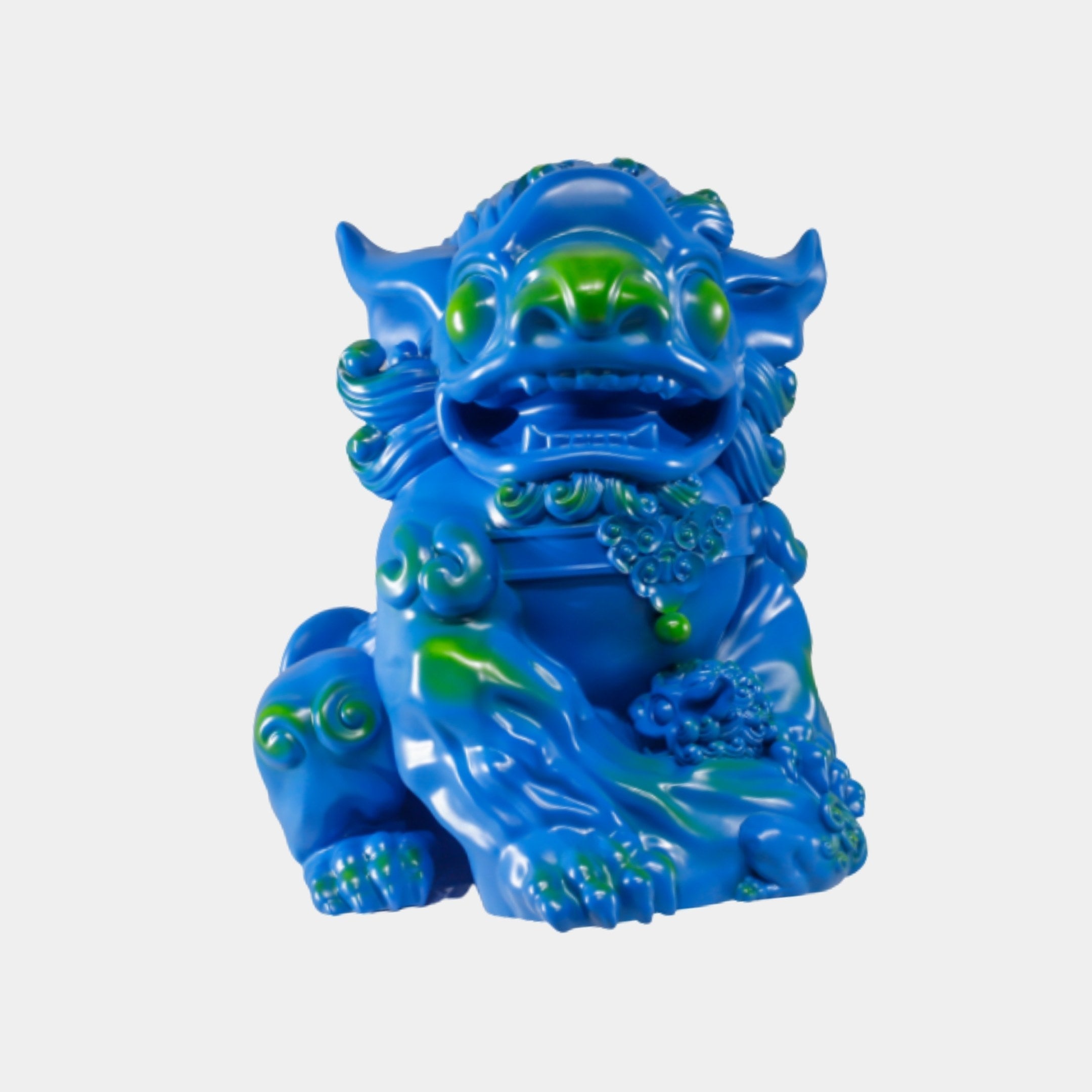 Blue Glazed Chinese Guardian Lion Sculpture by Giant Sculptures, seated foo-dog form in glossy blue resin with green highlights across mane and curls, on white.