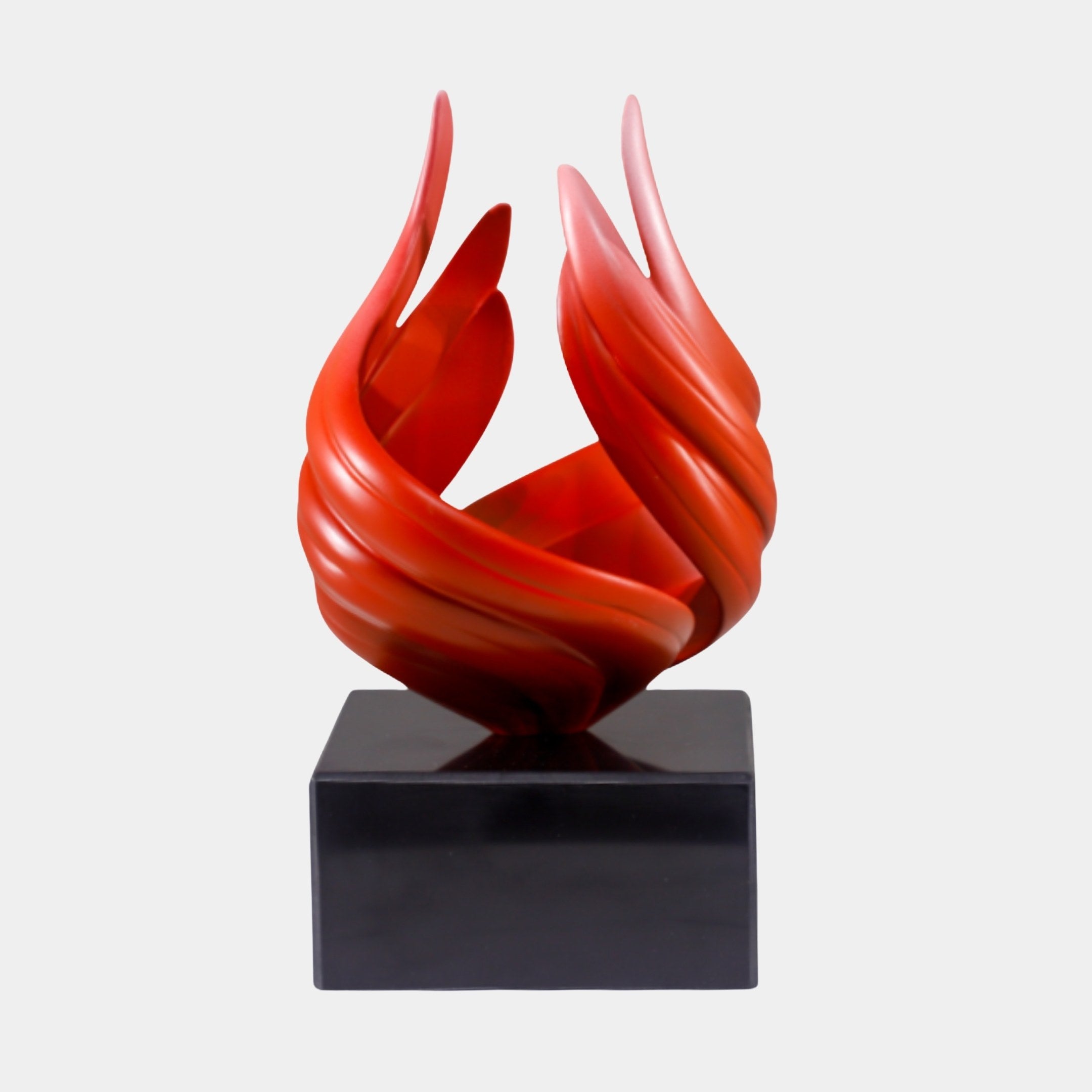 Red Abstract Flame on Black Base Sculpture by Giant Sculptures, featuring twisting glossy ribbons rising like fire on a polished black marble base.