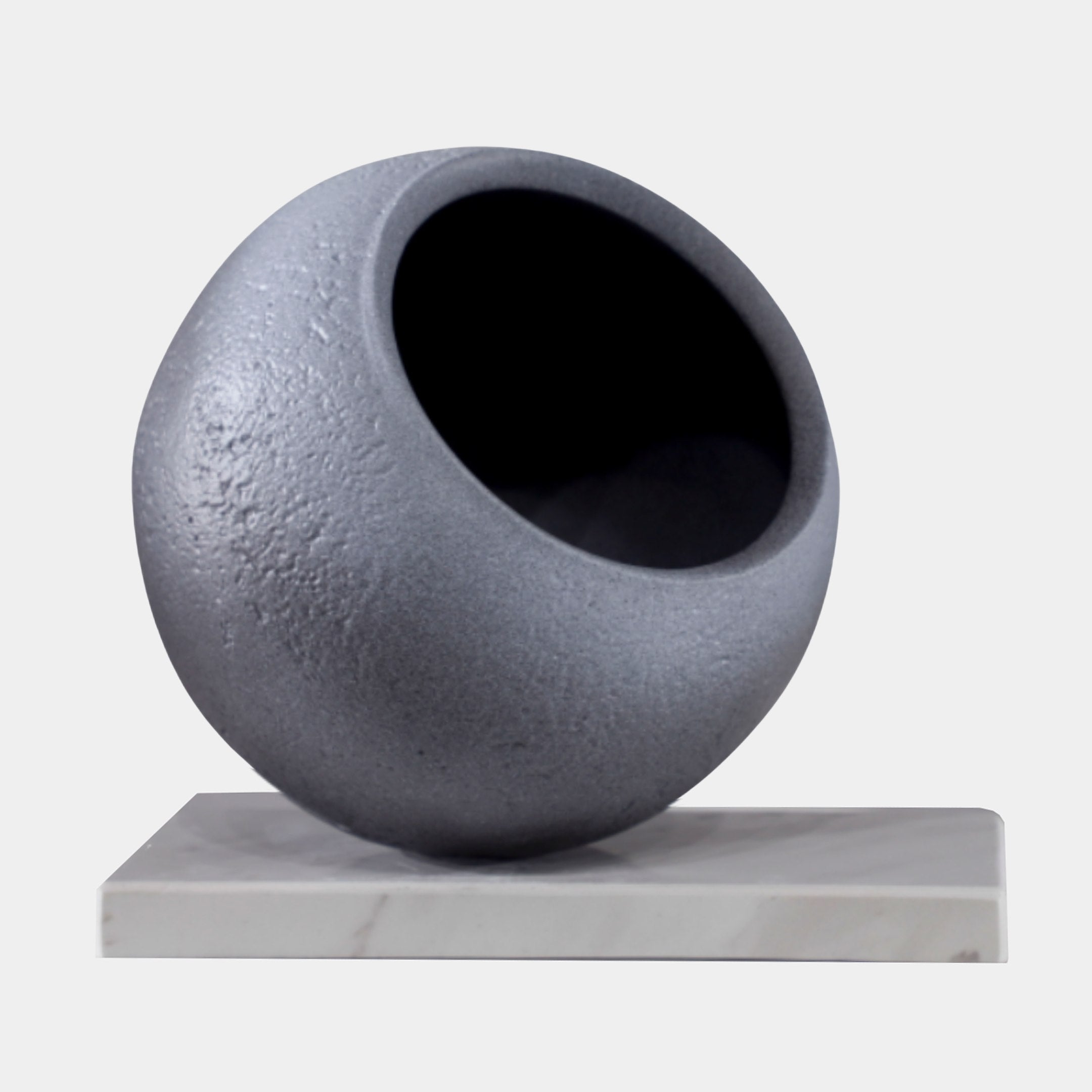 Grey Matte Sphere with Void Sculpture by Giant Sculptures, a textured 3D-printed resin orb with a deep circular opening, set on a white marble base.