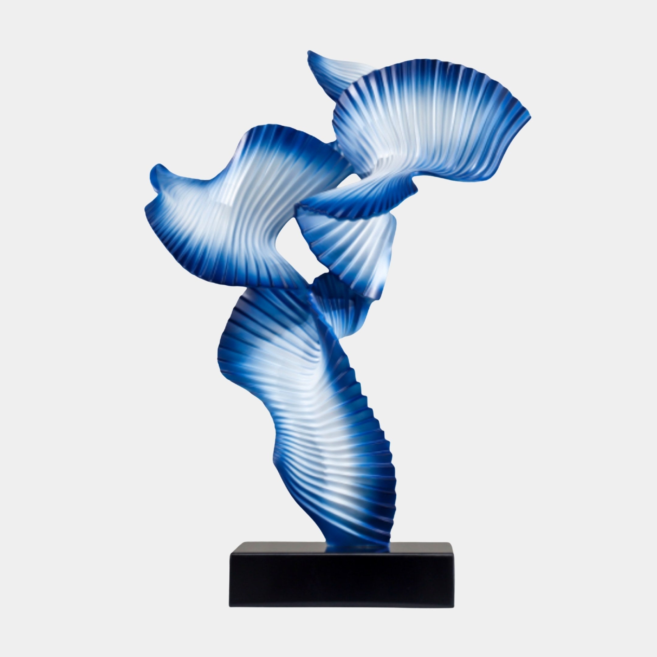 Blue Abstract Pleated Dancing Figure Sculpture by Giant Sculptures, with fan-like ribbons twisting upward on a dark rectangular base against a white background.