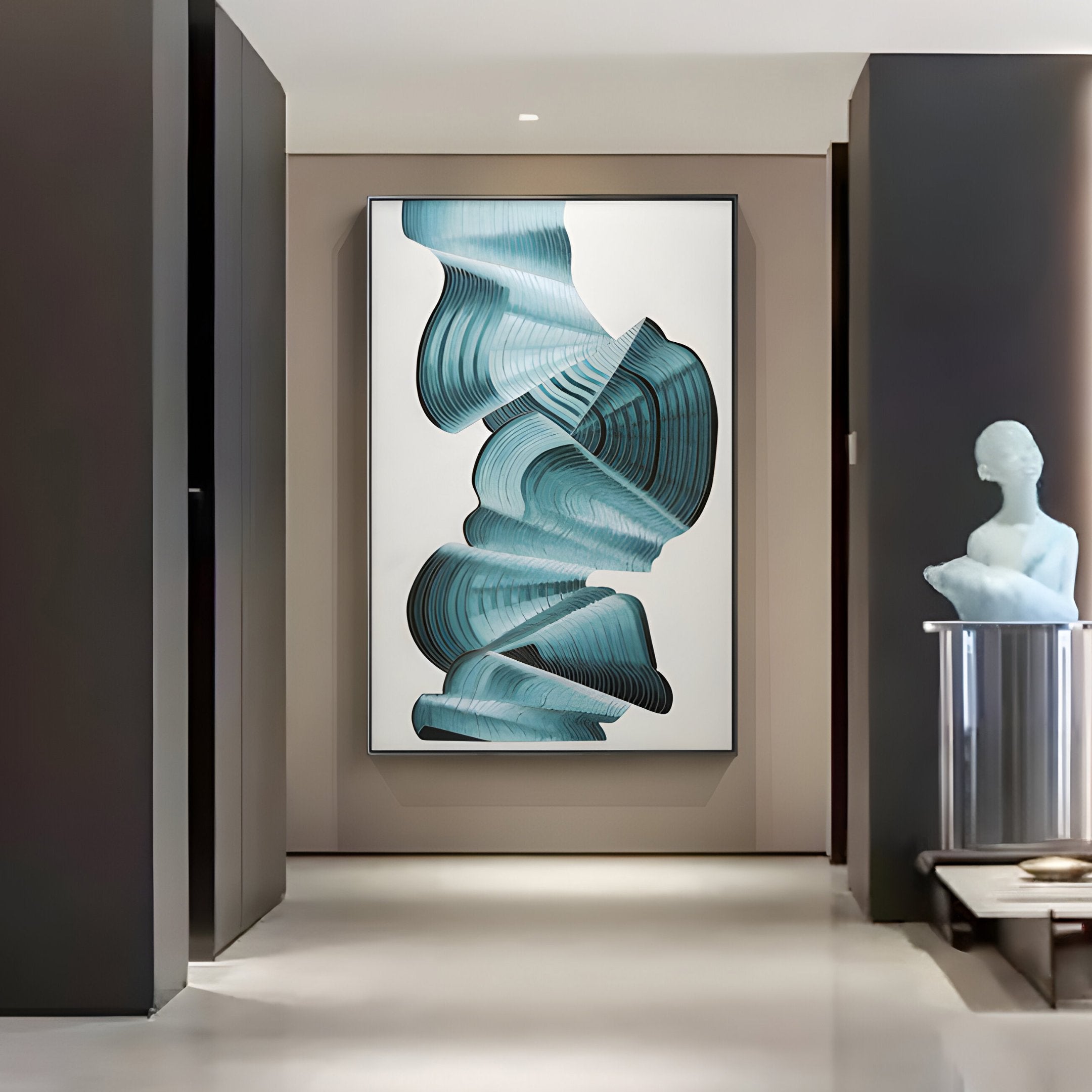 A modern hallway showcases the Vortex Blue Spiral Silver Copper Wire Enamel Abstract Wall Art from Giant Sculptures, featuring teal and gray swirling shapes. A minimalist statue on a pedestal graces the corner. The space is elegantly lit with contrasting dark and light walls.