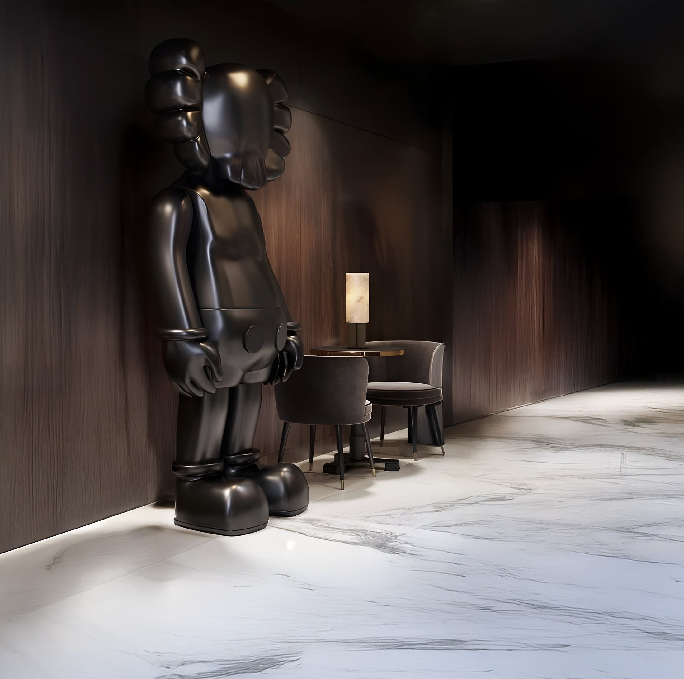 A Giant Sculptures Midnight Black Iconify Standing Sculpture (70cm) commands the dimly lit modern room with dark wood walls. A small table, two chairs, and a lamp complement the artistic decor on the sleek light marble floor.