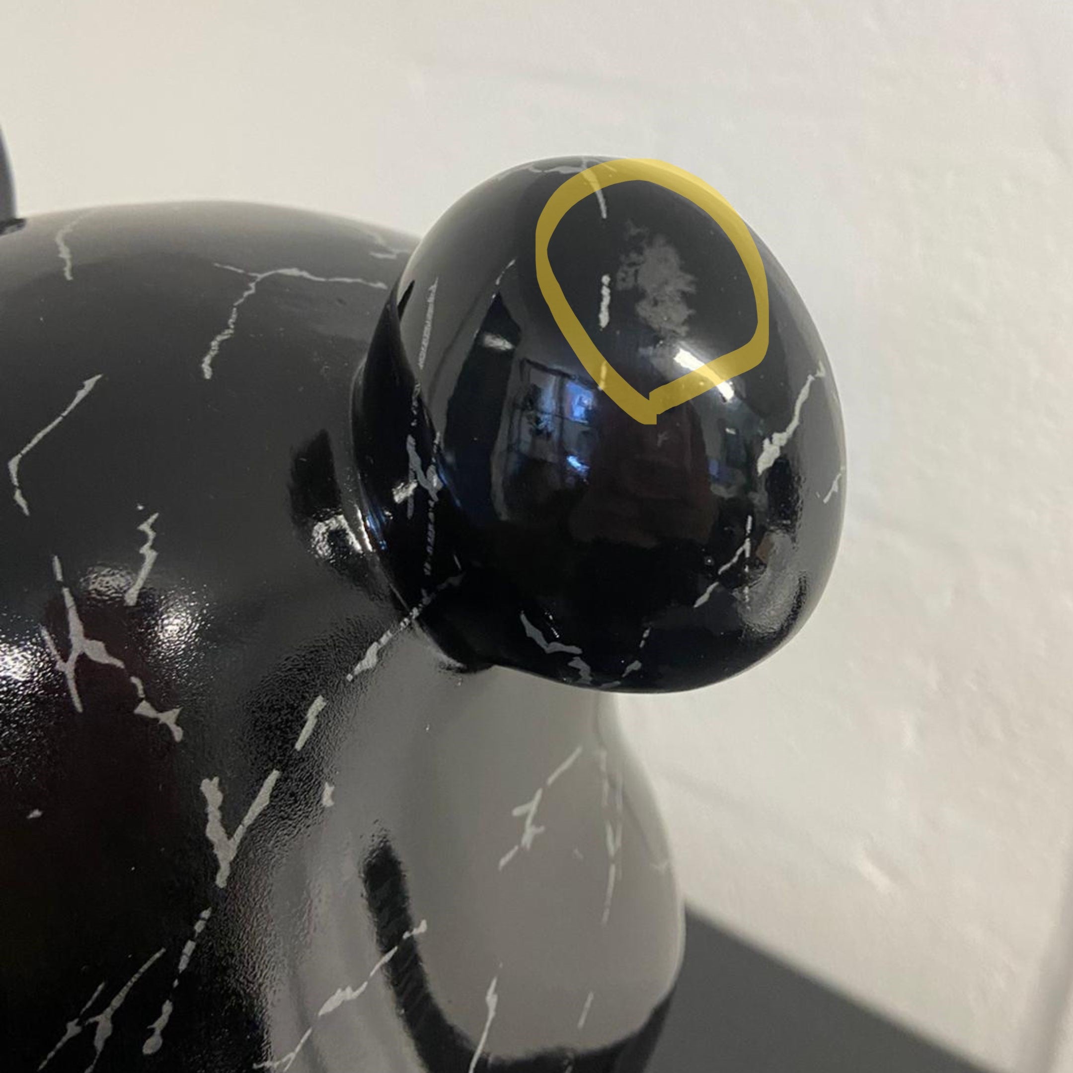 Close-up of the Black Stone Bear Sculpture by Giant Sculptures showing a marked area on the glossy black snout, highlighting ex-display finish damage.