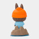 The Submarine Explorer Labubu Sculpture - 100cm by Giant Sculptures features Labubu from behind, in an orange beanie with ears, light blue shirt, and standing on a rocky base surrounded by blue water—a playful tribute to fibreglass-inspired art.