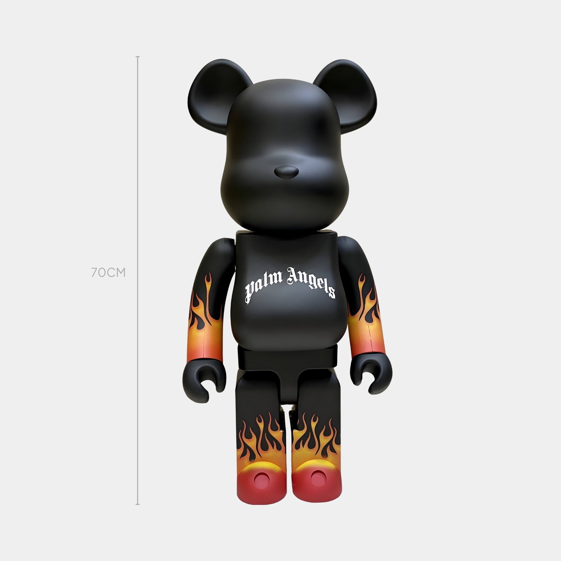 The Flame Black Bear Sculpture - 70cm by Giant Sculptures features a gothic-style logo on its chest and vivid orange-yellow gradient flames on its arms and legs, set against a plain light gray background.