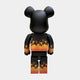 The Giant Sculptures Flame Black Bear Sculpture - 70cm is shown from behind, displaying orange and yellow gradient flames on its arms, torso, and legs against a plain light gray background.