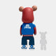Seen from behind, the Fresh Grizz Bear Sculpture - 50cm by Giant Sculptures sports streetwear: red hoodie, blue “Stay Fresh” jacket, blue pants, and blue-white shoes. A right-side shadow completes this limited edition collectible.