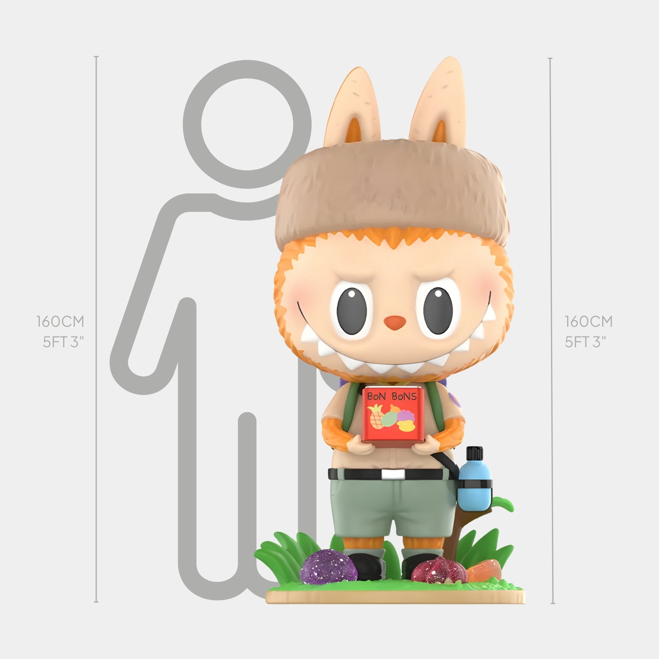 The Fruit Filled Candy Labubu Sculpture - 160cm by Giant Sculptures features a cute figure in a bunny-eared hat, holding a Bon Bons box. It stands beside a 160 cm height chart on grass with colorful stones—a charming collectible art piece.