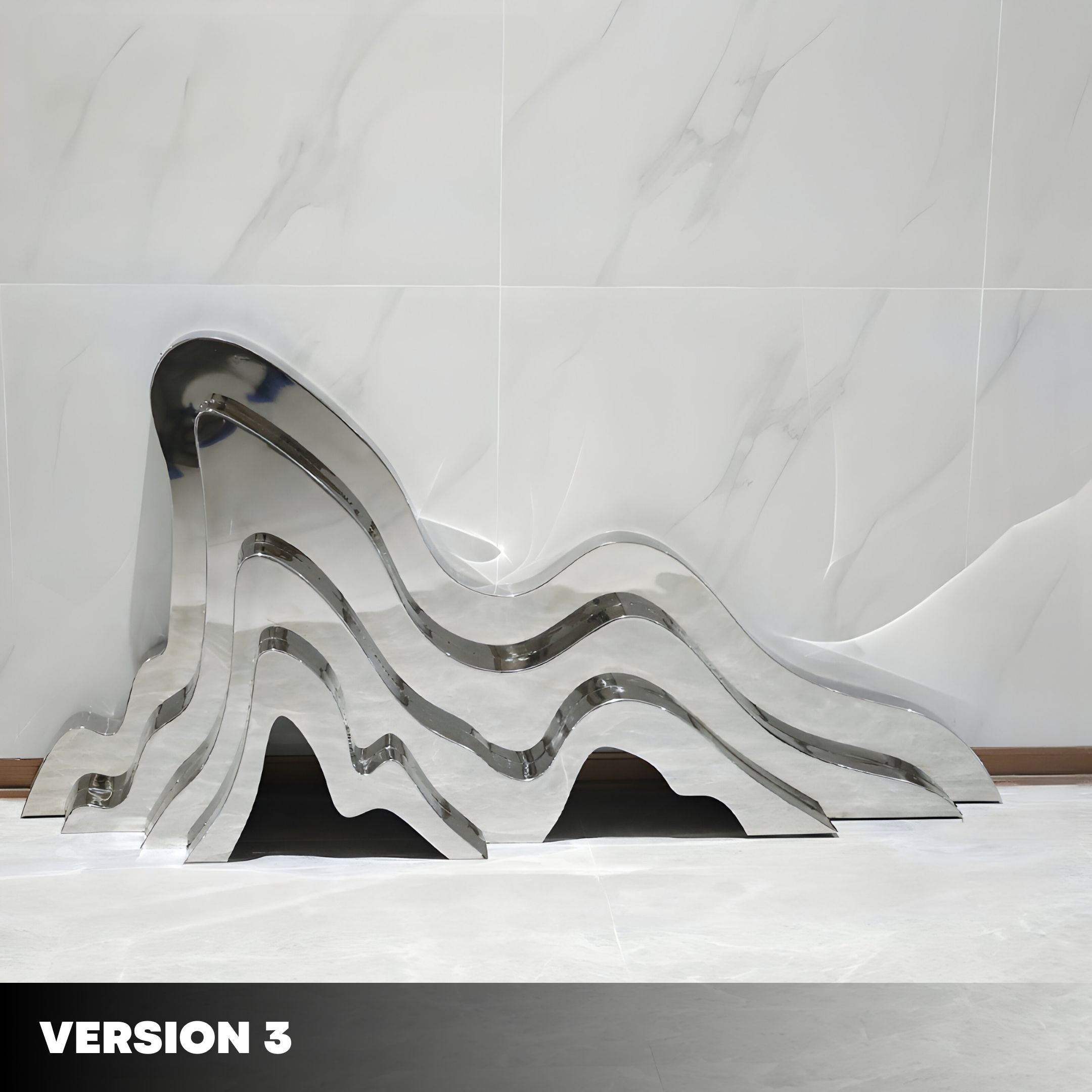 The Mountain Range Silver Abstract Steel Sculpture by Giant Sculptures features undulating layers that reflect light on a polished white marble floor. A matching marble wall forms the background, with Version 3 in bold white text epitomizing modern arts sleek elegance.