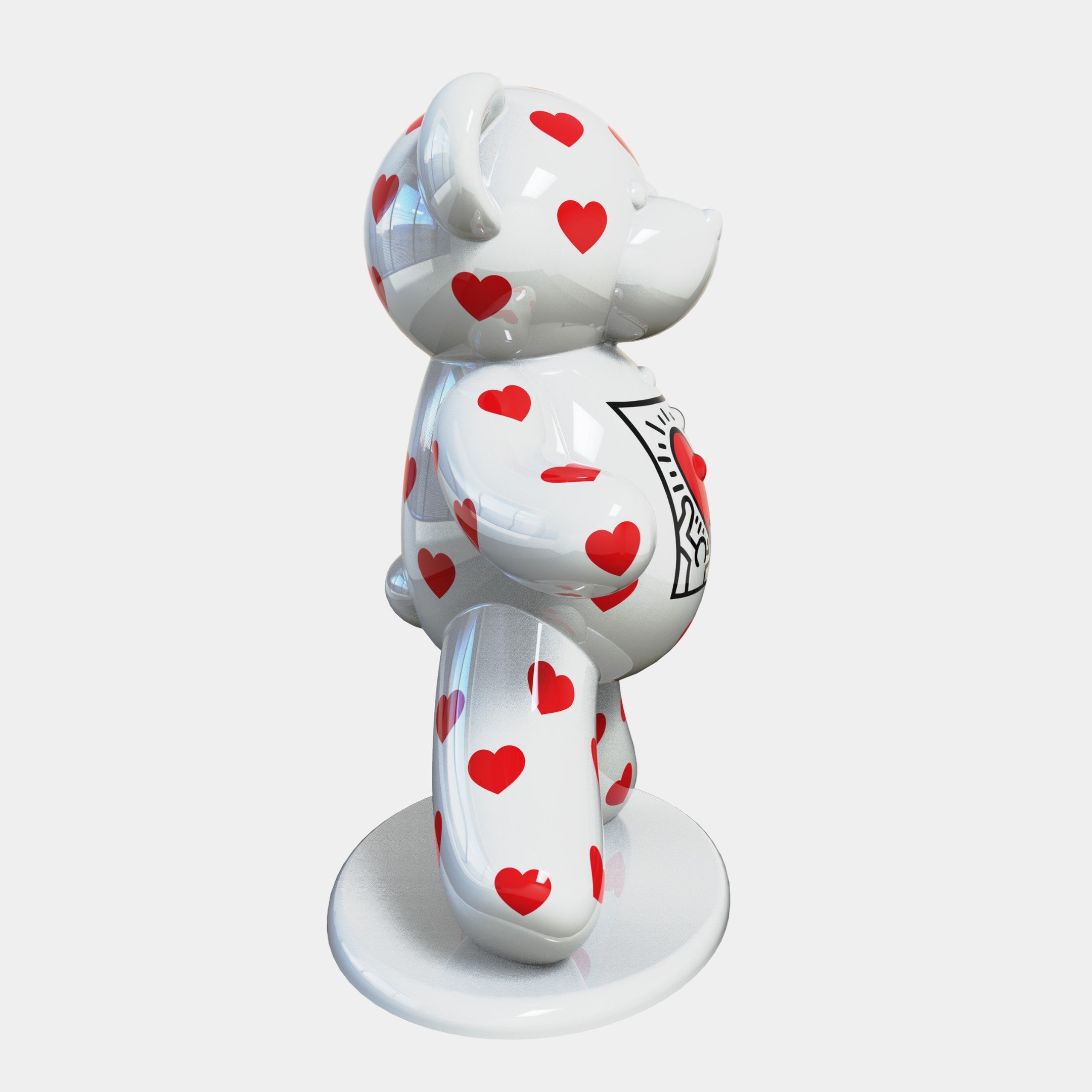 The Gacko Keith Haring White Bear Sculpture by Giant Sculptures stands 165cm tall, featuring glossy bear with red heart patterns on a round base. This limited edition predominantly white piece showcases a King of Hearts symbol on its chest, styled in black and red, echoing Keith Harings pop art flair.