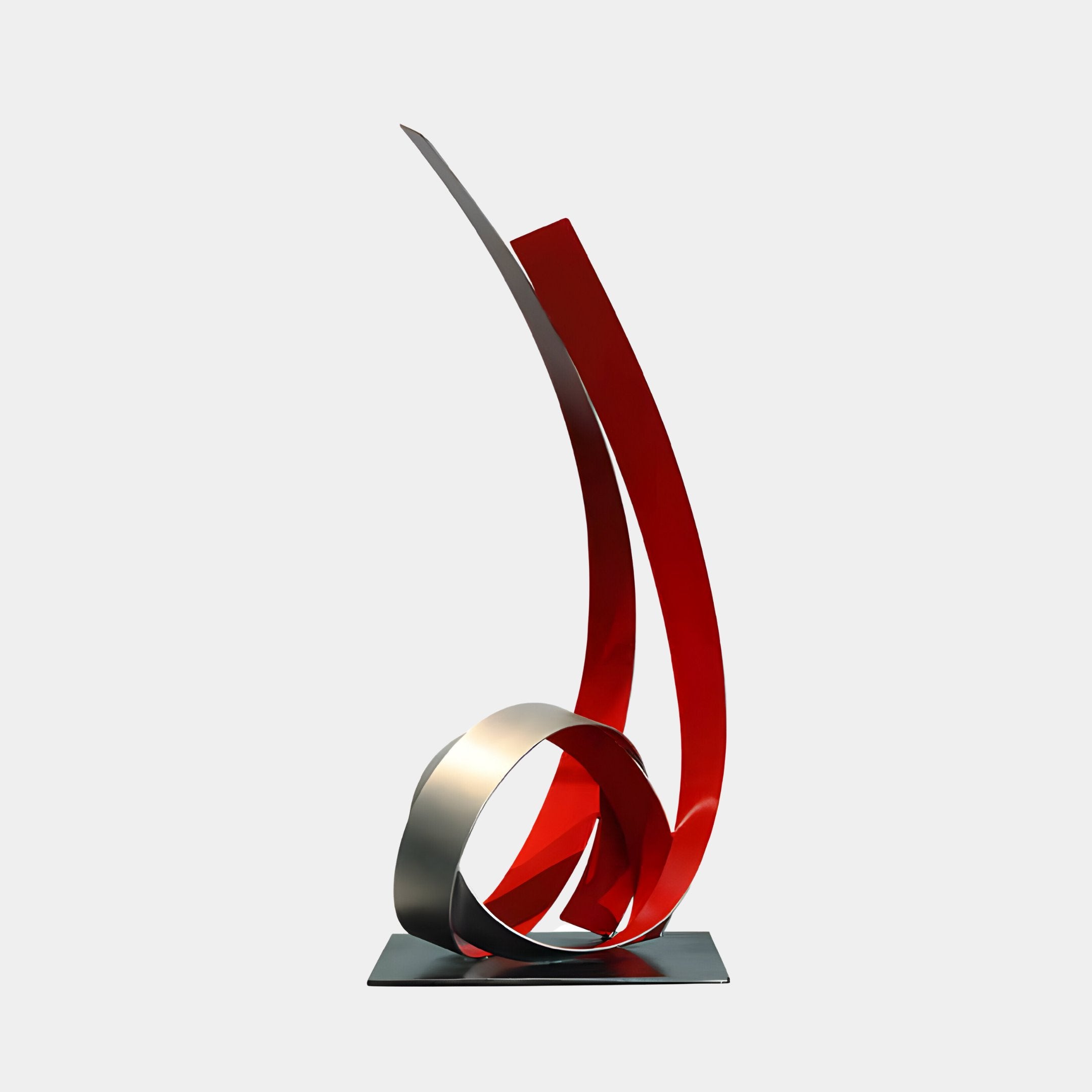 The Ribbon Red Abstract Steel Sculpture by Giant Sculptures is a 73cm modern artwork, featuring a twisting metal ribbon that extends upward, anchored by a circular loop at the base. This weather-resistant masterpiece stands elegantly against a plain white background.