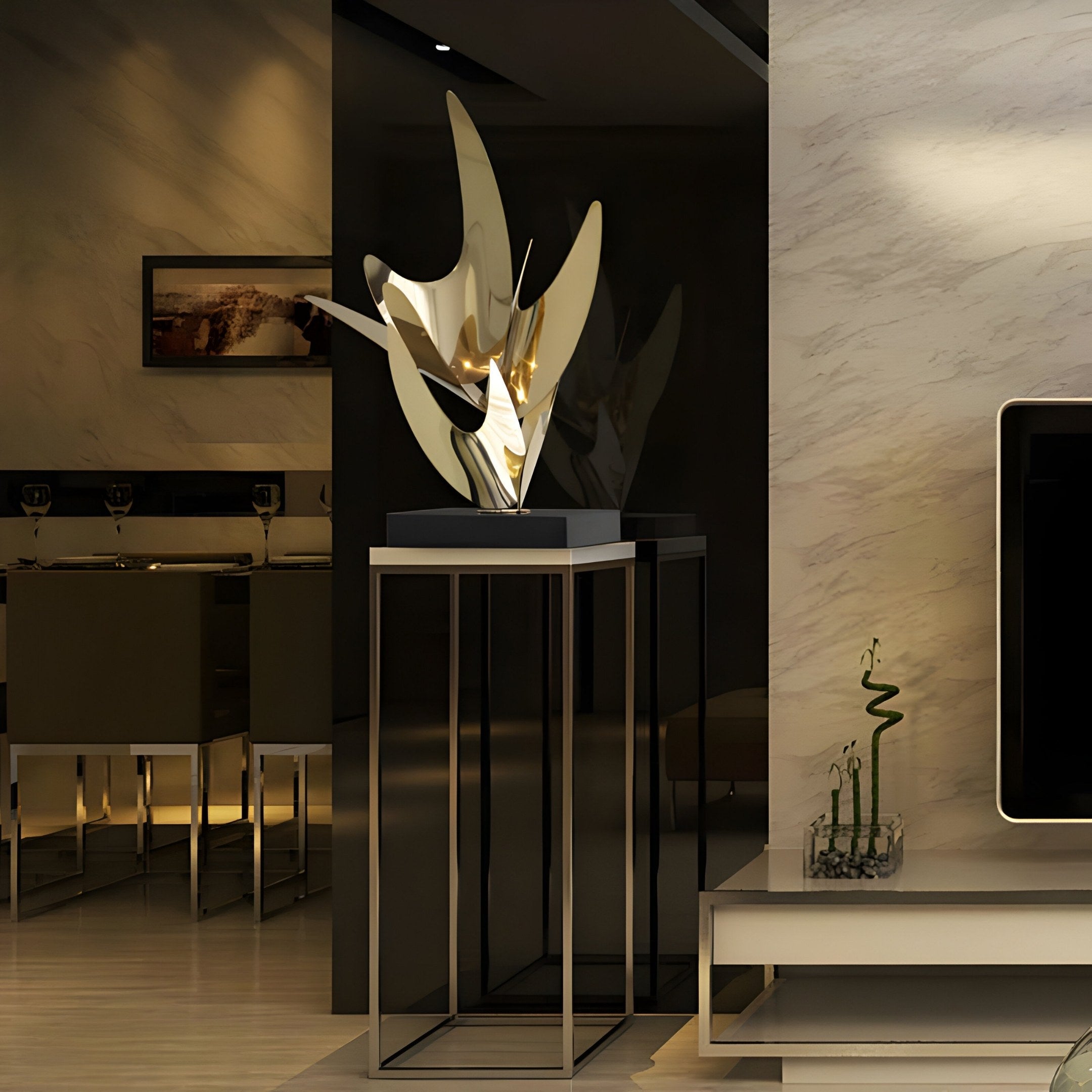 A modern living room showcases the Zephyr Gold Abstract Steel Sculpture (71cm) by Giant Sculptures on a tall metal stand, complementing the minimalist decor. With neutral tones, a flat-screen TV, a decorative plant on a white console, and soft ambient lighting add an elegant touch.