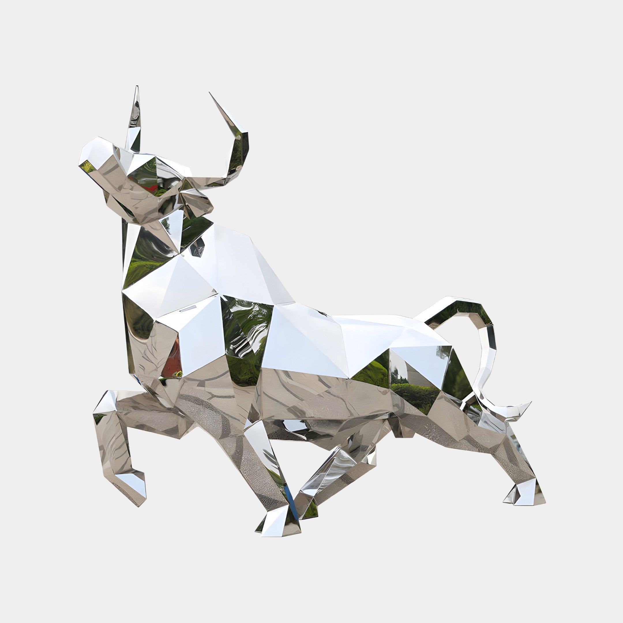 Abstract geometric bull sculpture in a polished metallic finish, showcasing sharp angles and a modern design aesthetic.