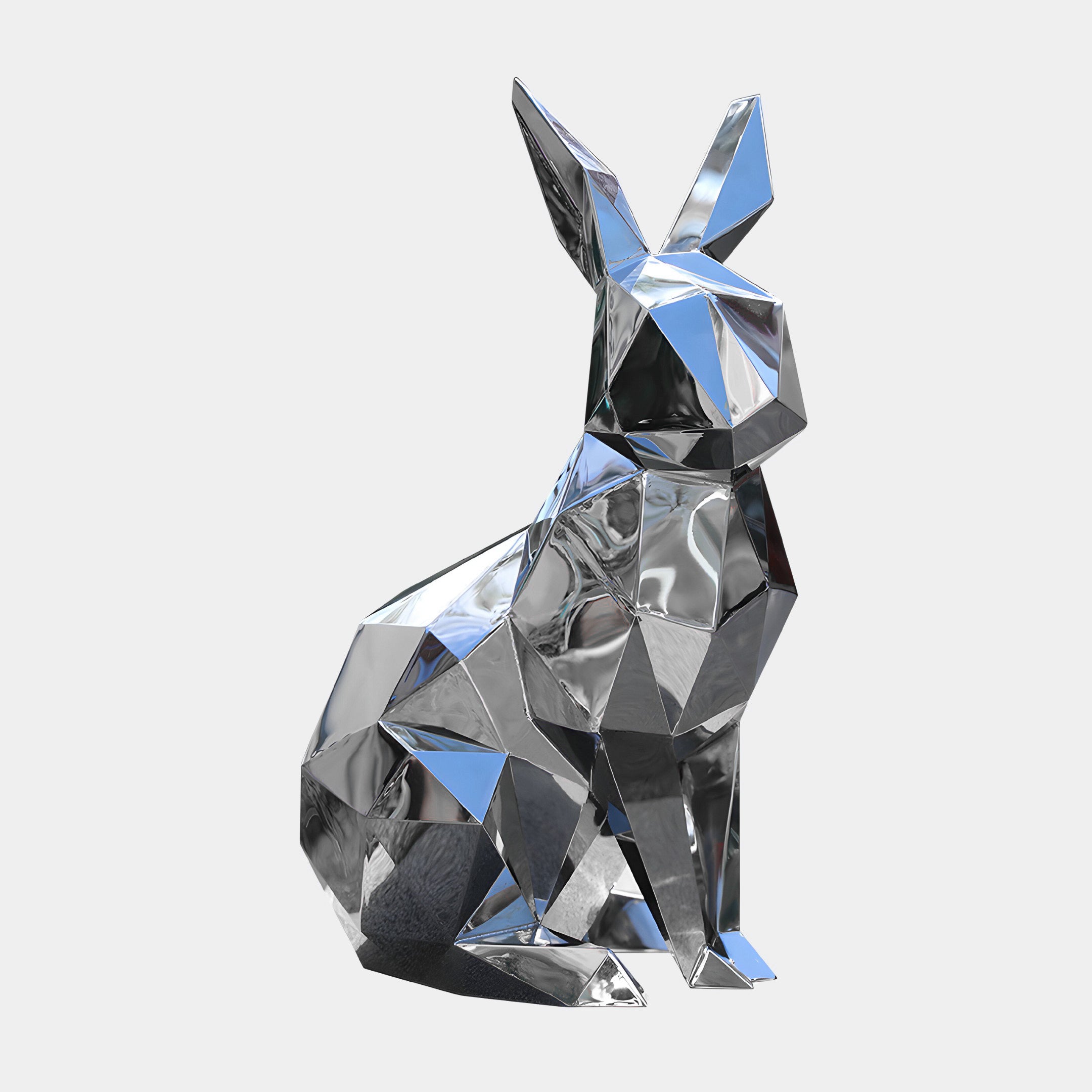 A shimmering "Coco Rabbit Steel Outdoor Sculpture - 61cm" by Giant Sculptures, crafted from metallic polygons, is set elegantly against a plain white background, offering a perfect modern wildlife accent for outdoor spaces.