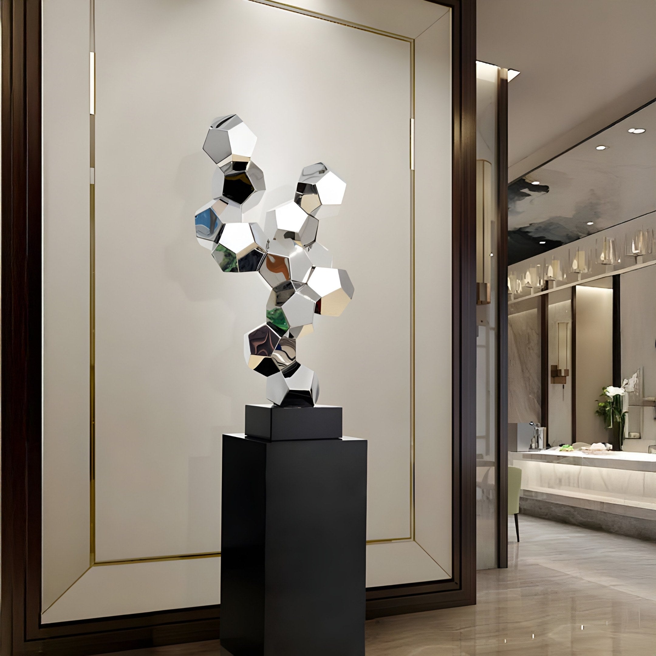 The Dynamo Silver Geometric Steel Sculpture - 104cm by Giant Sculptures is a modern abstract piece featuring interlocking geometric shapes in stainless steel on a black pedestal, enhancing any sophisticated interior with its contemporary allure against large walls and polished floors.