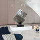 Sculpture positioned on a modern white table, integrating well with the minimalist décor.