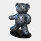 The Gacko Grey LV Bear Sculpture by Giant Sculptures, standing 165cm tall, features interlocking LV and floral motifs in a glossy silver finish. This limited edition Pop Art piece by André Gacko embodies luxury and sophistication with its modern design on a black oval base.