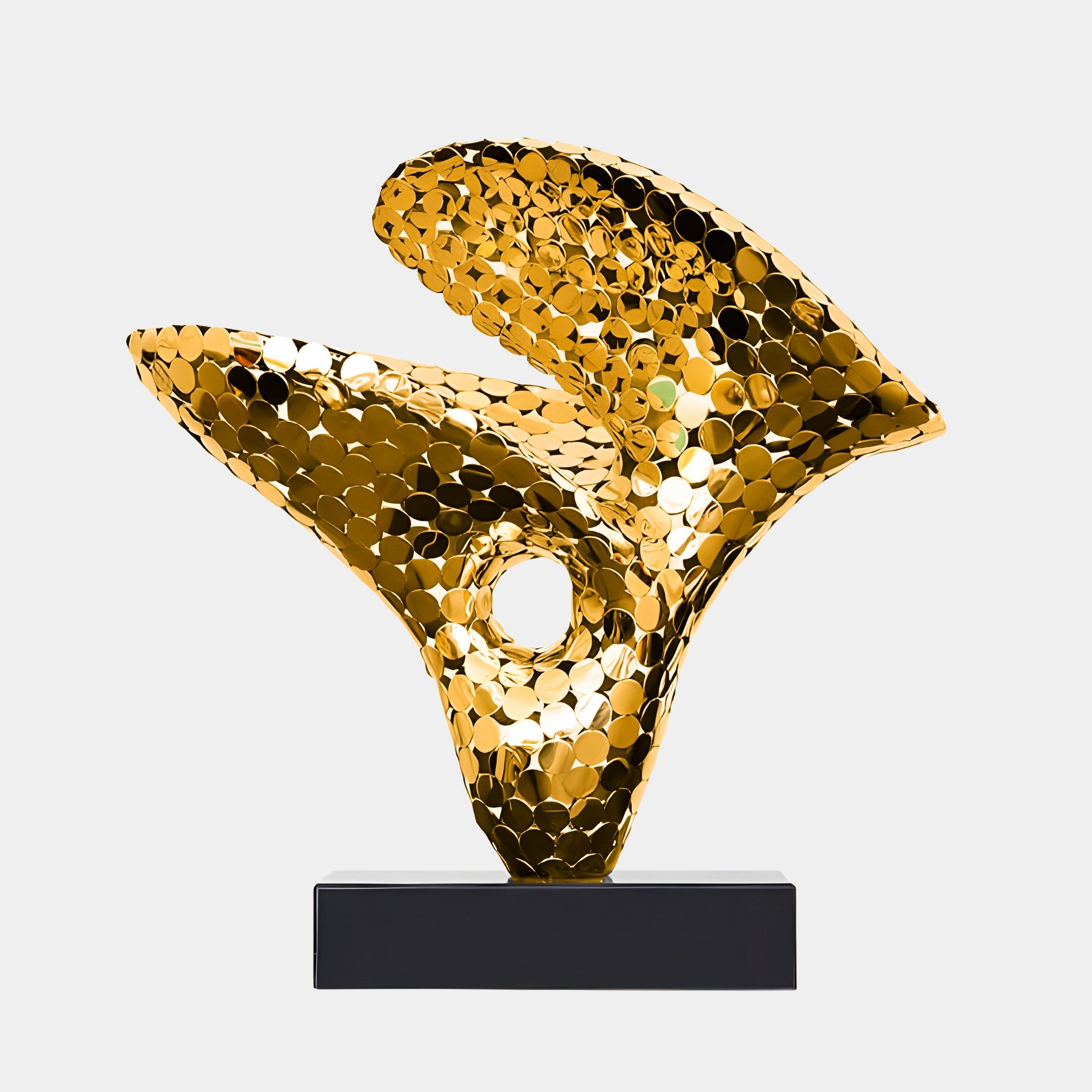 Abstract golden sculpture with reflective surface and curving organic forms on a black base.